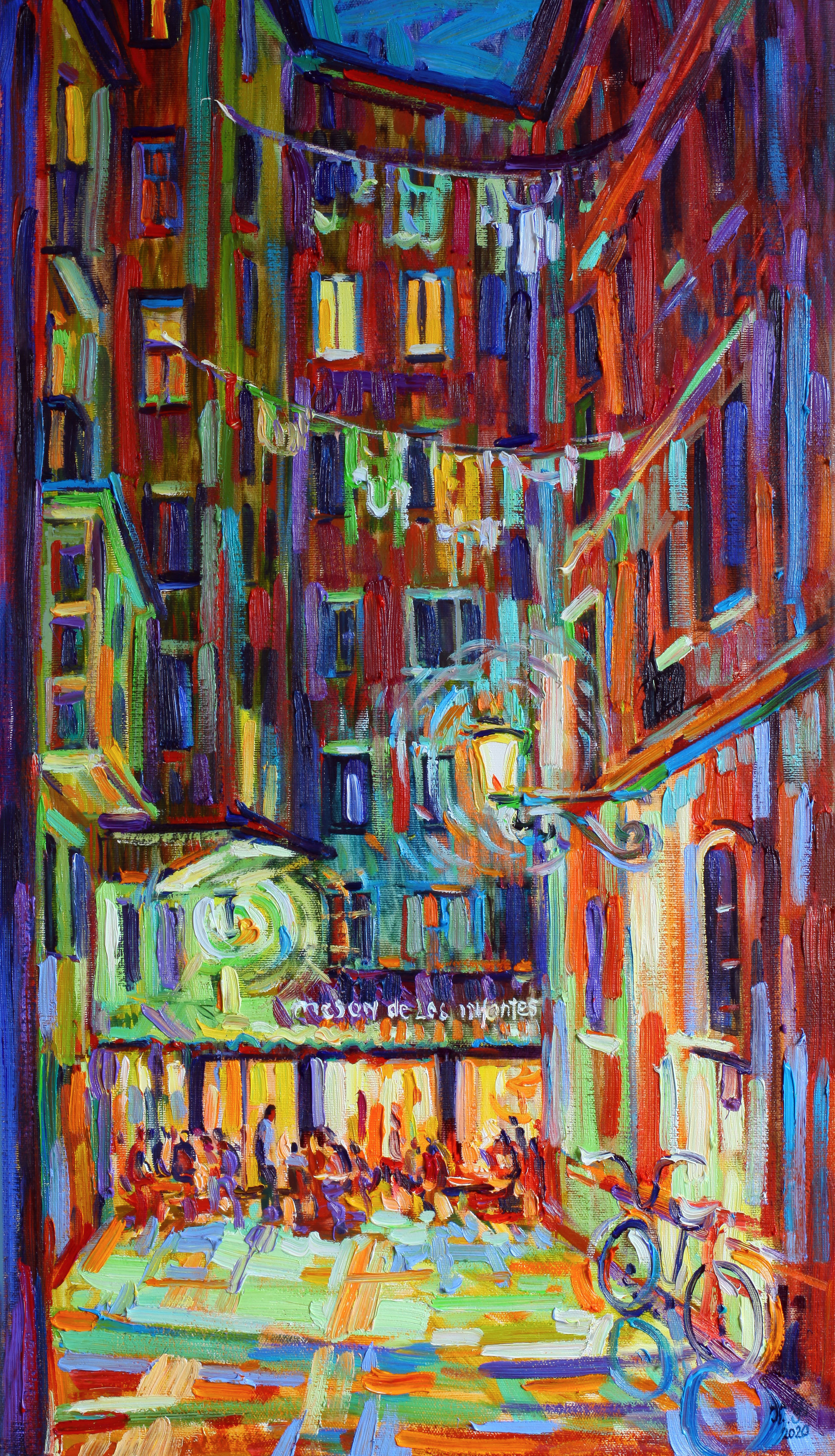 Illuminated street leading to the Mesón de los Infantes bar at night.