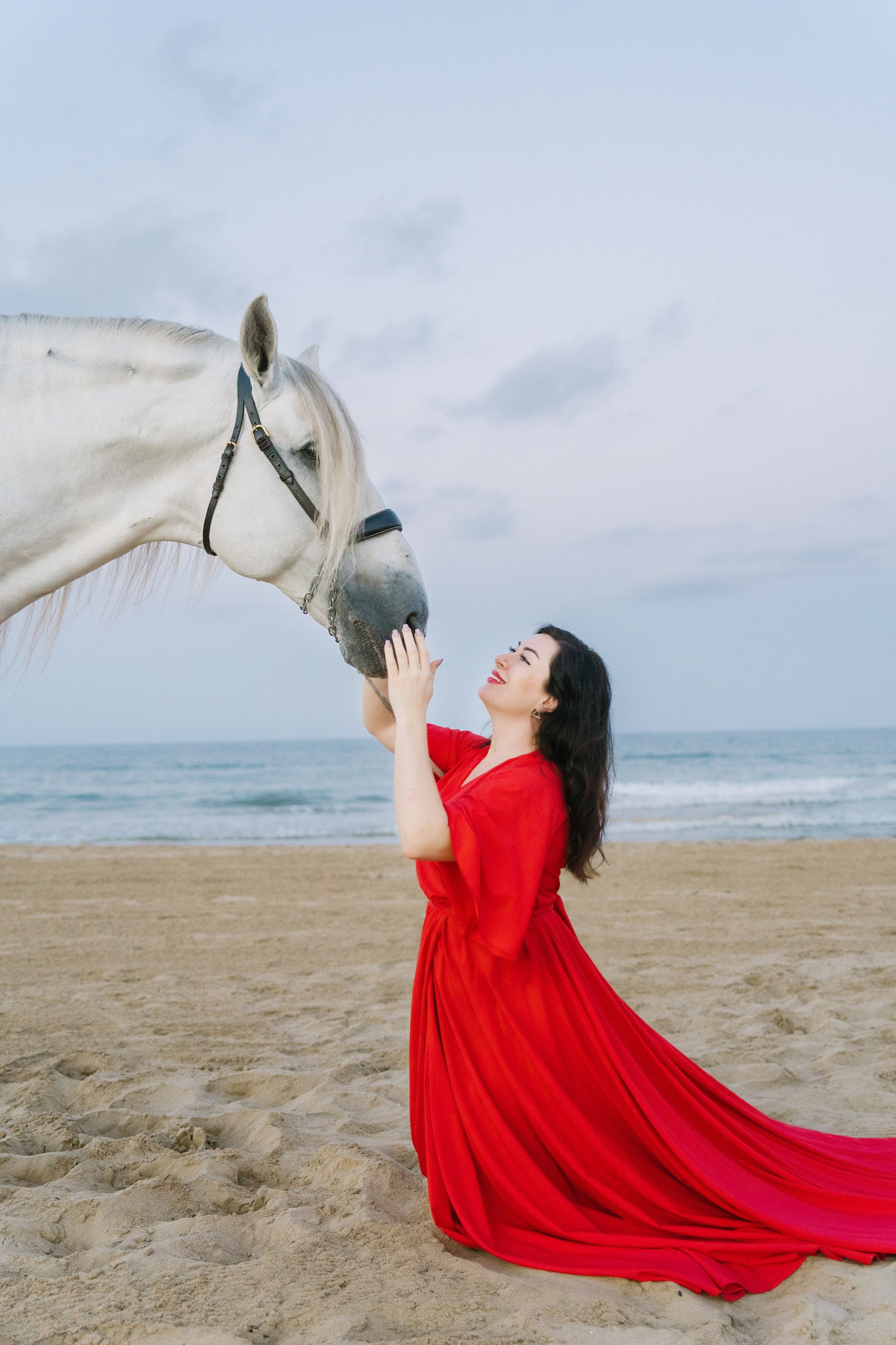 девушка в красном и конь на берегу моря