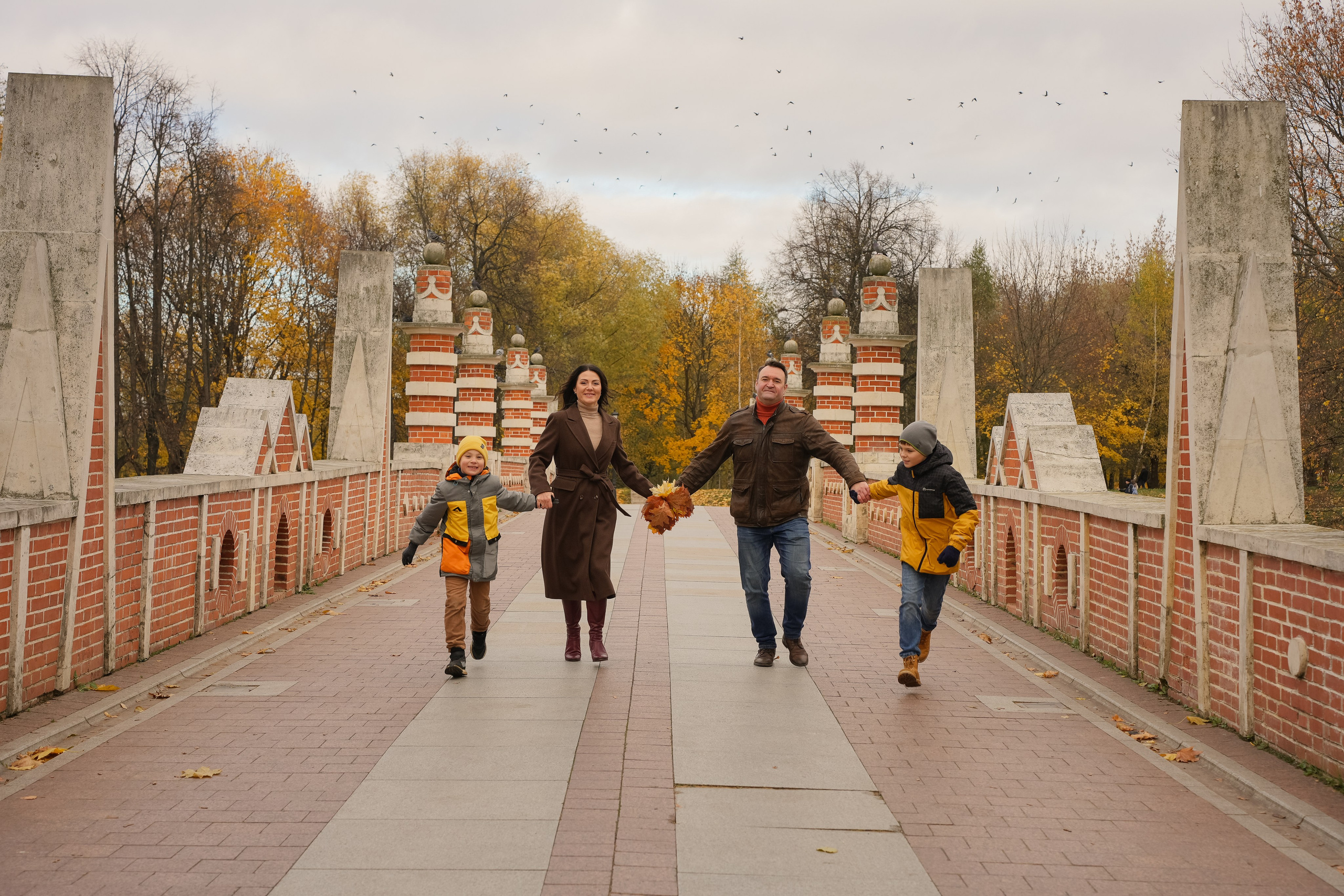 Семья на фотопрогулке золотой осенью