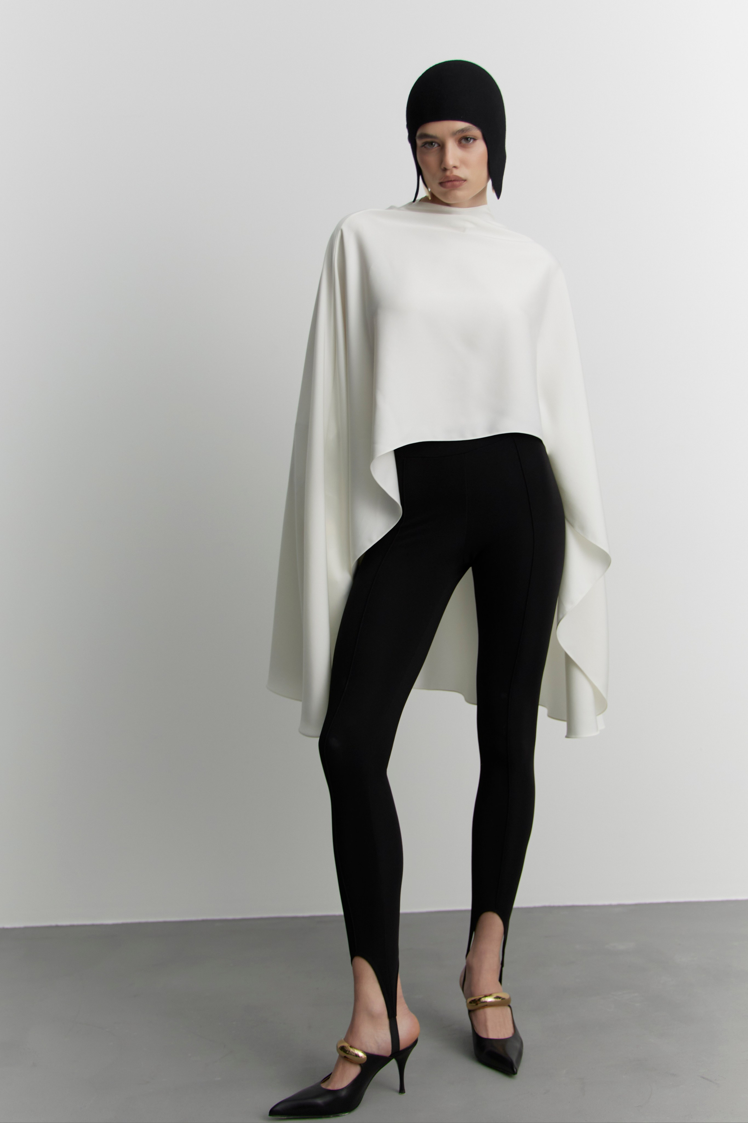 Minimalist fashion lookbook image of model in modern white top and black trousers photographed for fashion brand campaign in Sydney studio