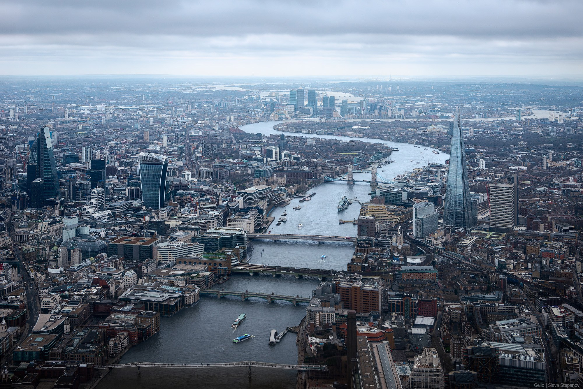 Global elevated panorama of London. The winding River Thames, The Shard skyscraper, Tower Bridge, and the City business district. "Cities of the World" photography, Slava Stepanov.