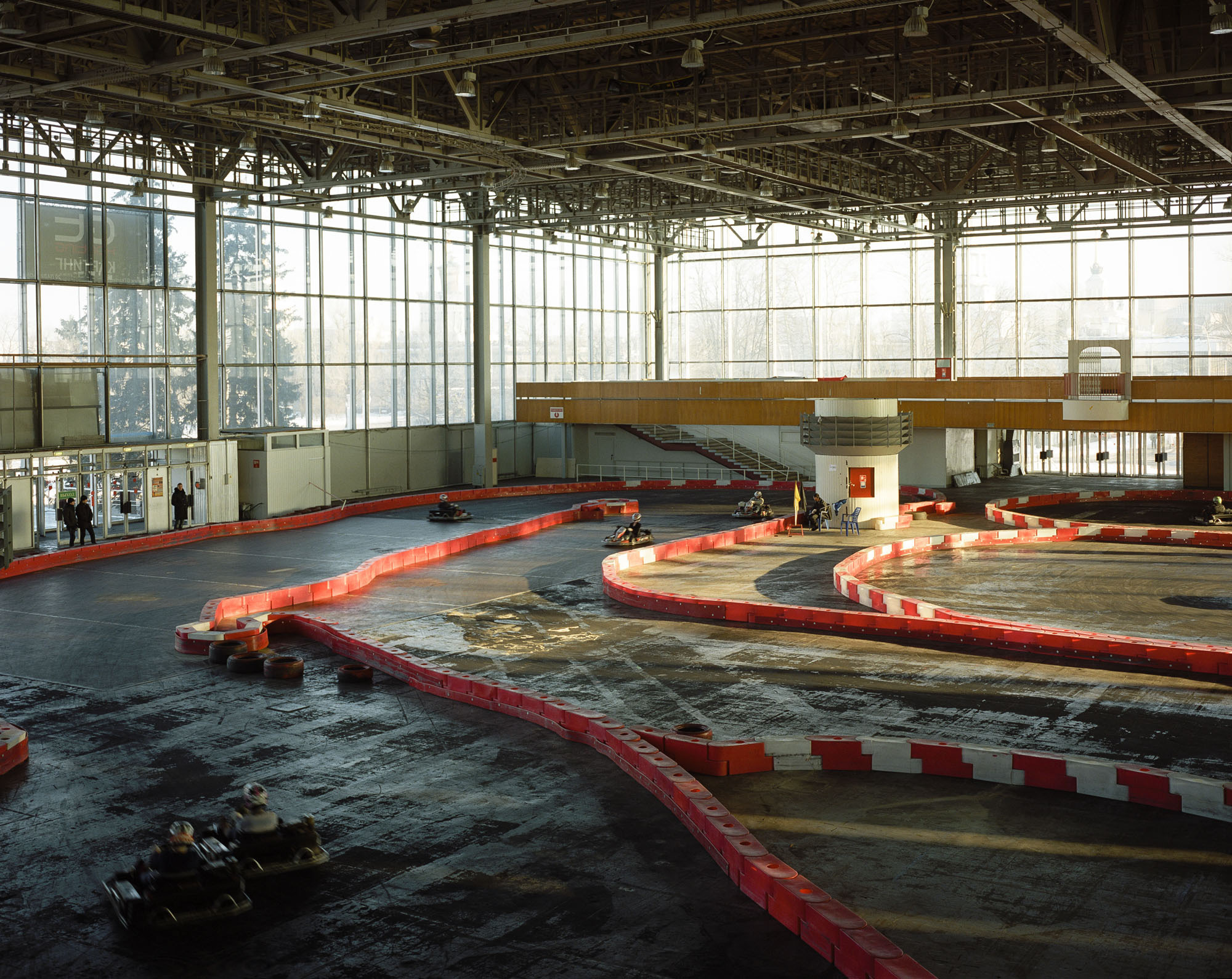 PLATE 60: Indoor racetrack c/w karts, figures of racers, plastic barriers, flags, plastic furniture, figures of people
