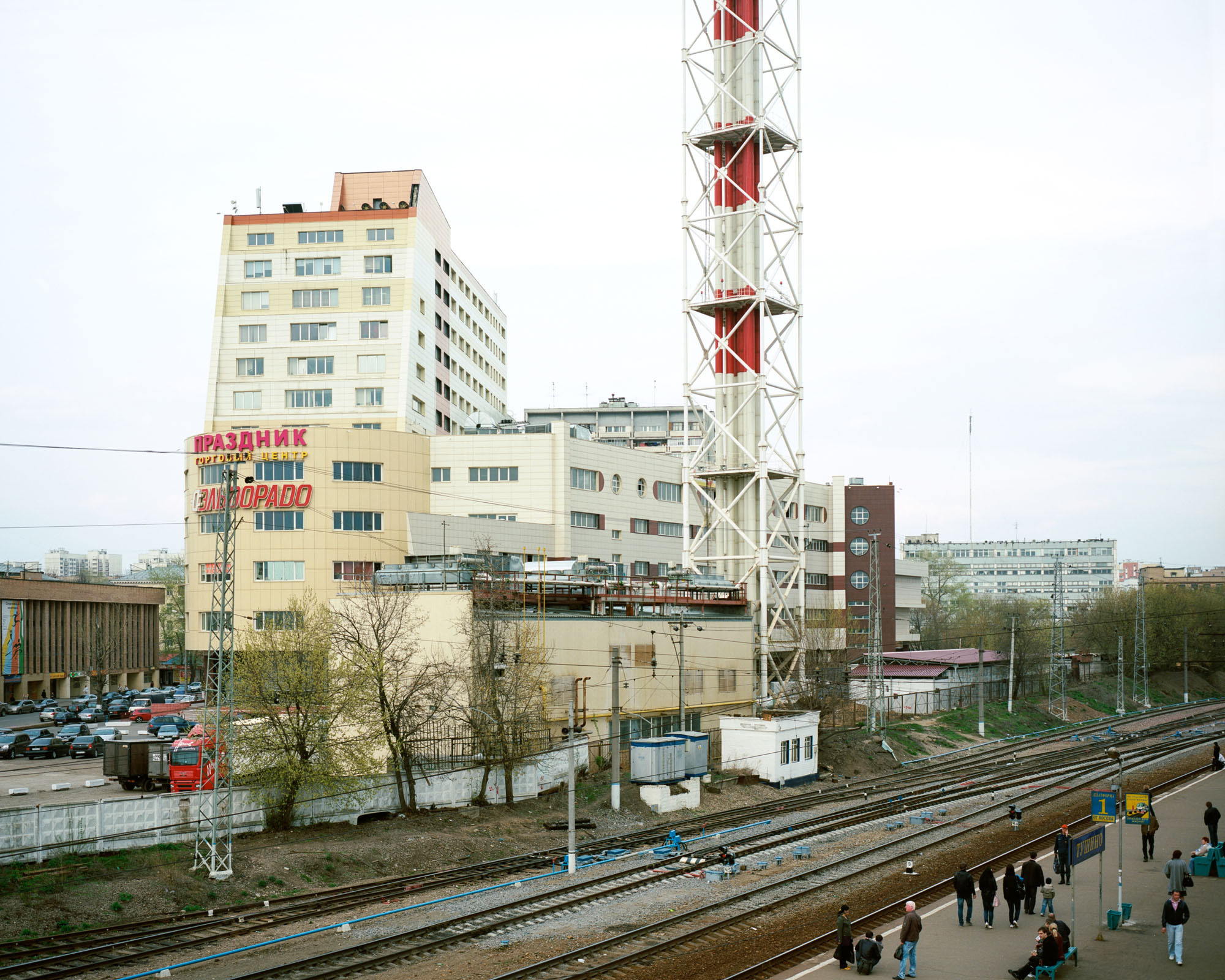 PLATE 16: Railway platform, shopping mall with parking space, assorted utility buildings, boiler house c/w chimney (also includes assorted vehicles, railway tracks, trees, figures of people, crushed rock, power lines, assorted barriers)