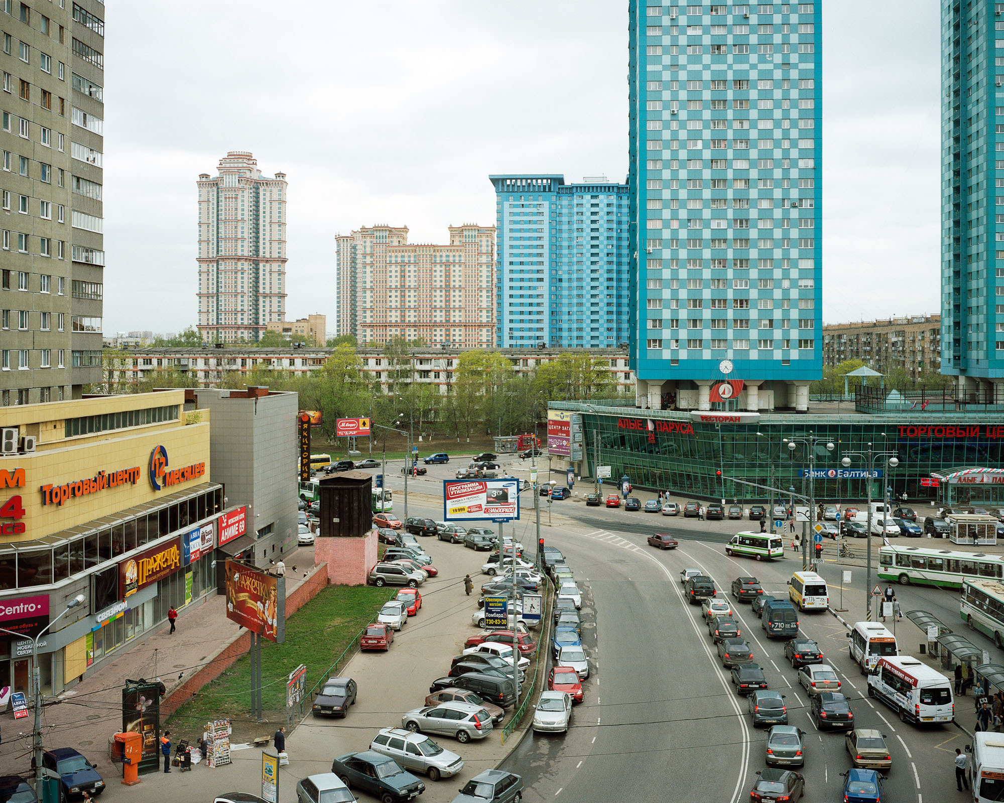 PLATE 10: 3-way junction, residential buildings, shopping malls (also includes figures of people, billboards and signage, buses, cars, kiosks, bus stops, payment kiosk, traffic lights and road signs, tram tracks, lamp posts, power lines, 	two types of clocks, A/C units)