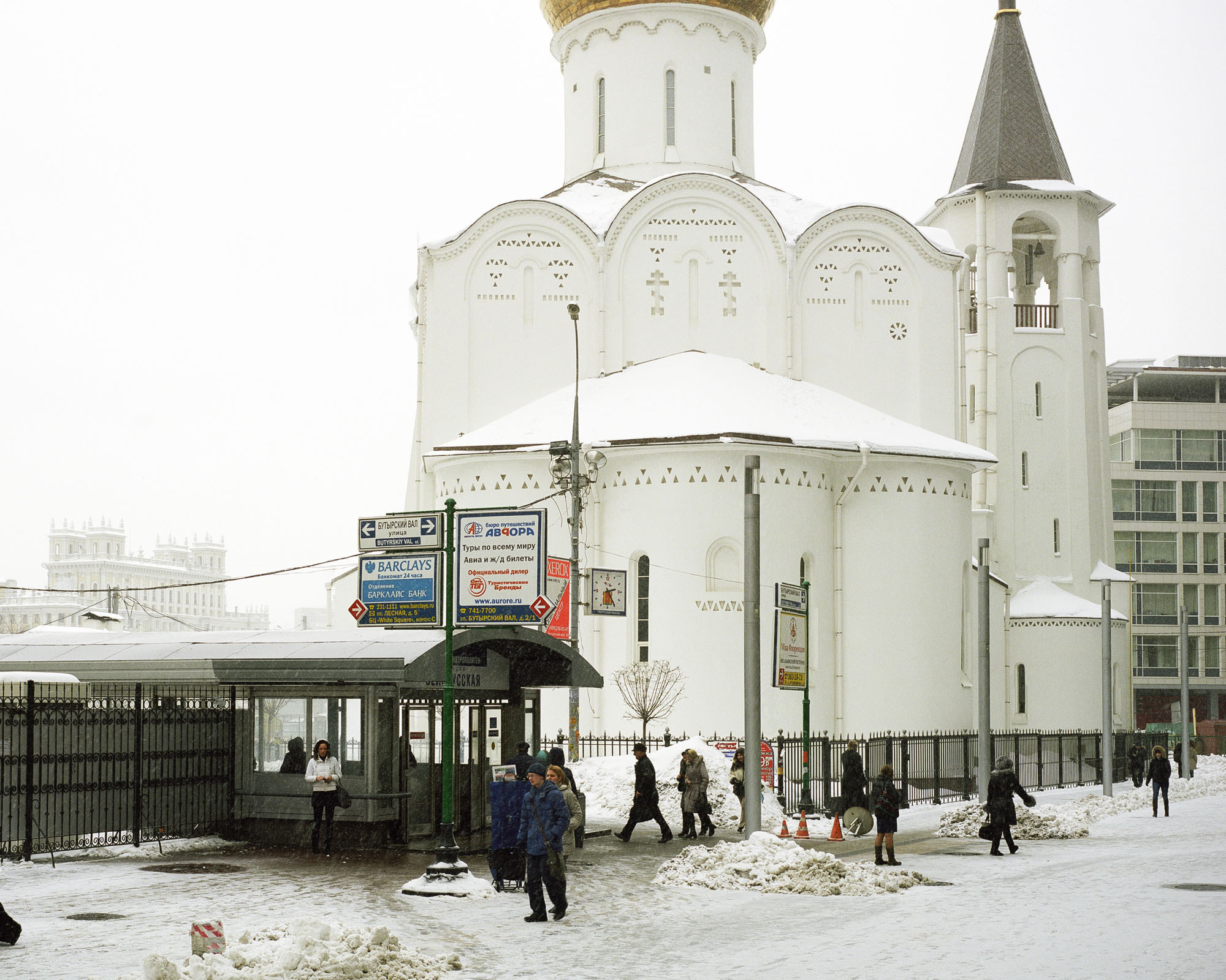 PLATE 13: Church building, modern office building, covered subway exit, lamp posts (incl. clock and assorted signs), power lines, barrier cones, two kinds fence, figures of people