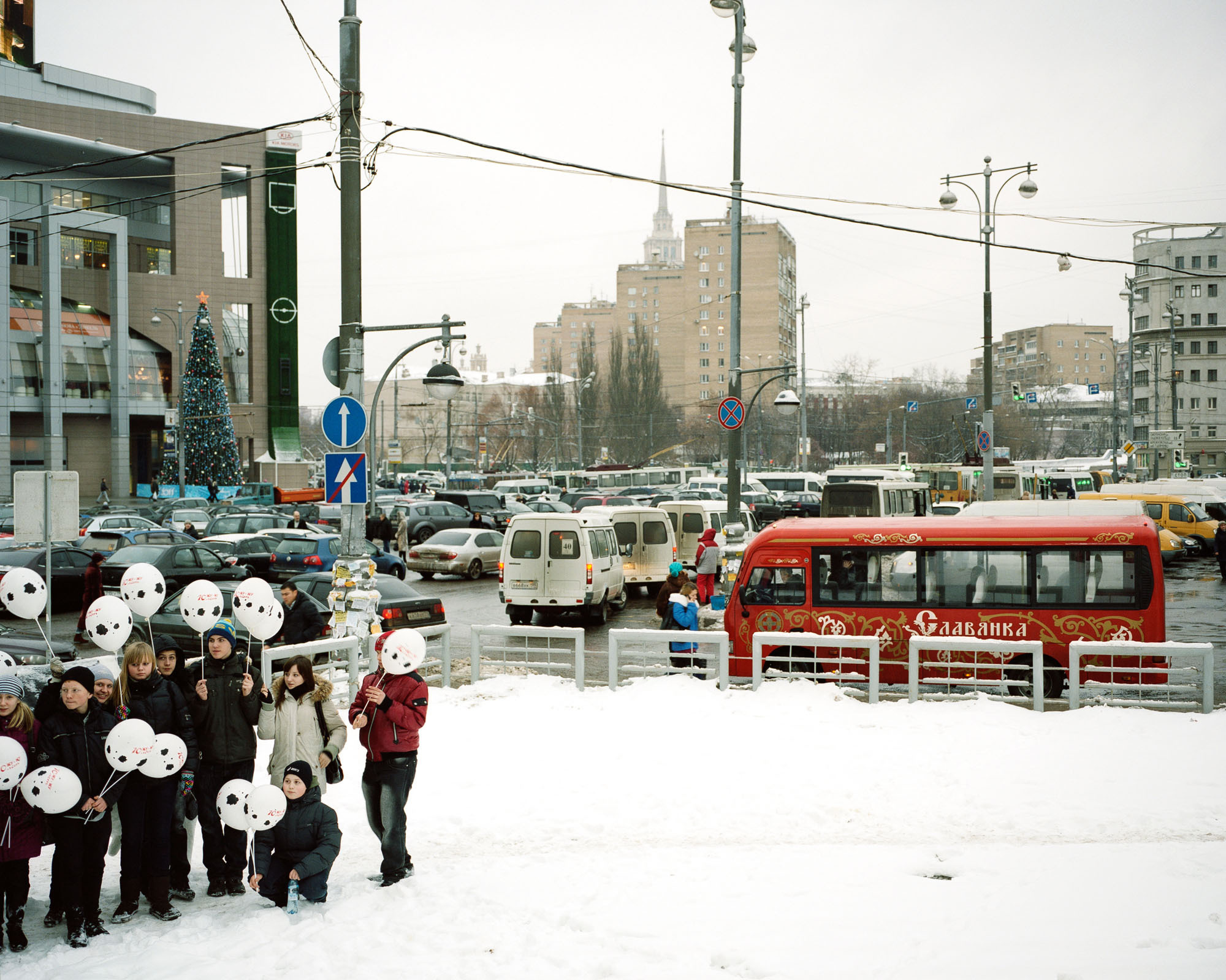 PLATE 22: Residential buildings, shopping mall, buses, figures of people at leisure, road signs, traffic lights, Christmas tree, snow, cars, barriers, lamp posts, power lines