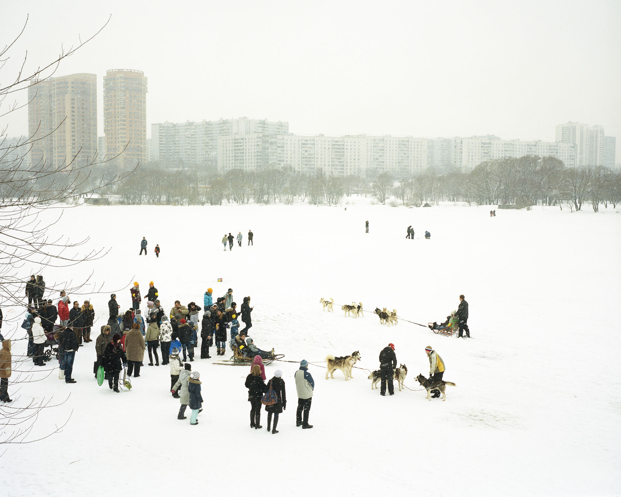 PLATE 38: Residential buildings, figures of people at leisure, assorted sledges and baby strollers, figures of dogs, 	trees, winter landscape