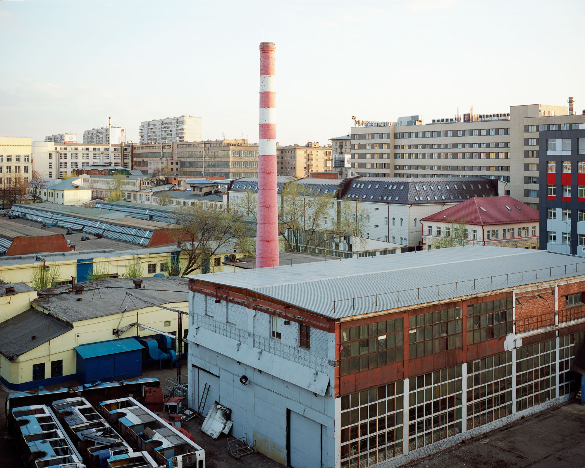 PLATE 17: Trolleybus depot, chimney, trolleybuses, industrial compound, office buildings, trees