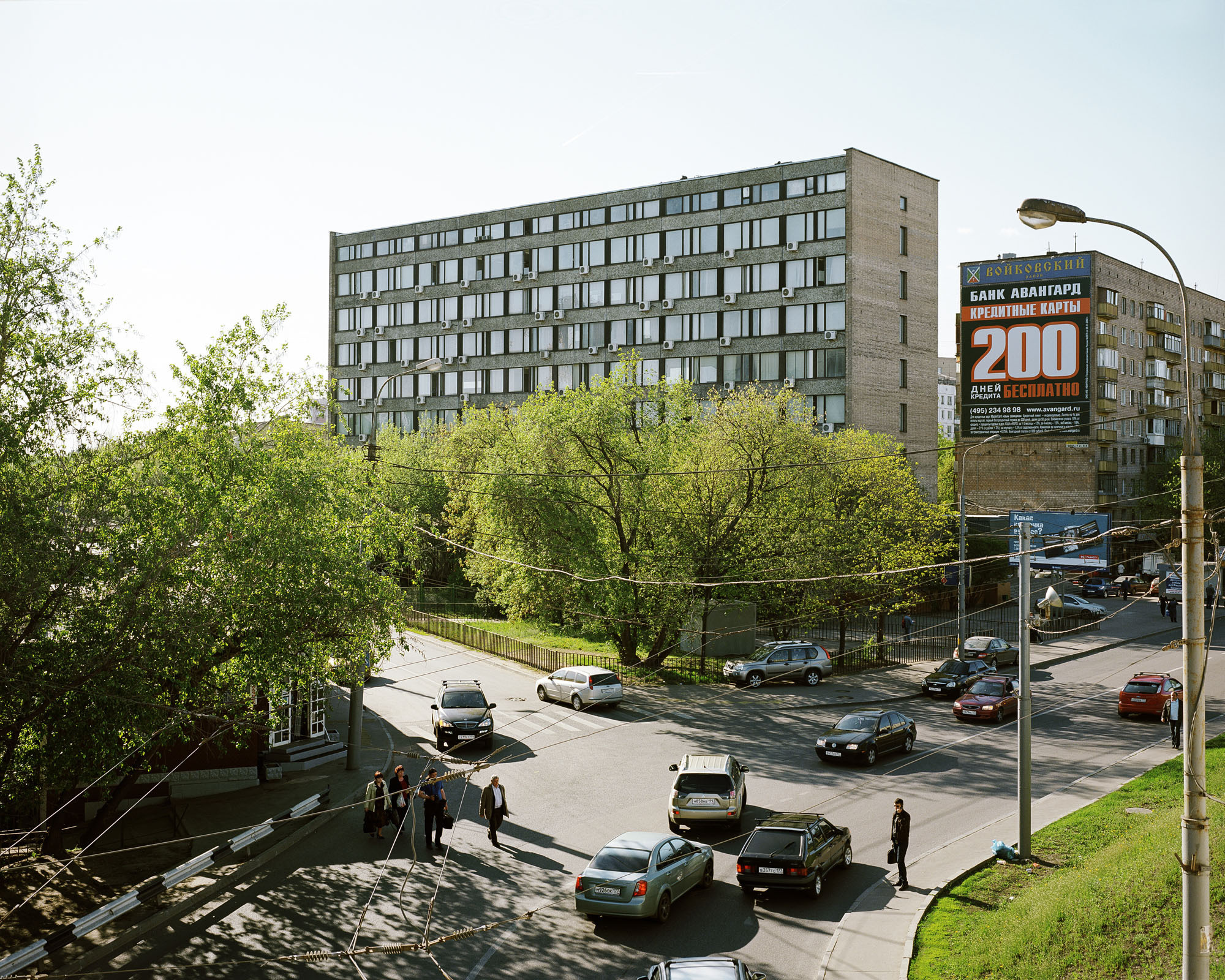 PLATE 1: T-junction, office building, residential building, billboards, lamp posts with power lines, assorted barriers, cars, figures of people, pedestrian crossing, grass, trees, A/C units