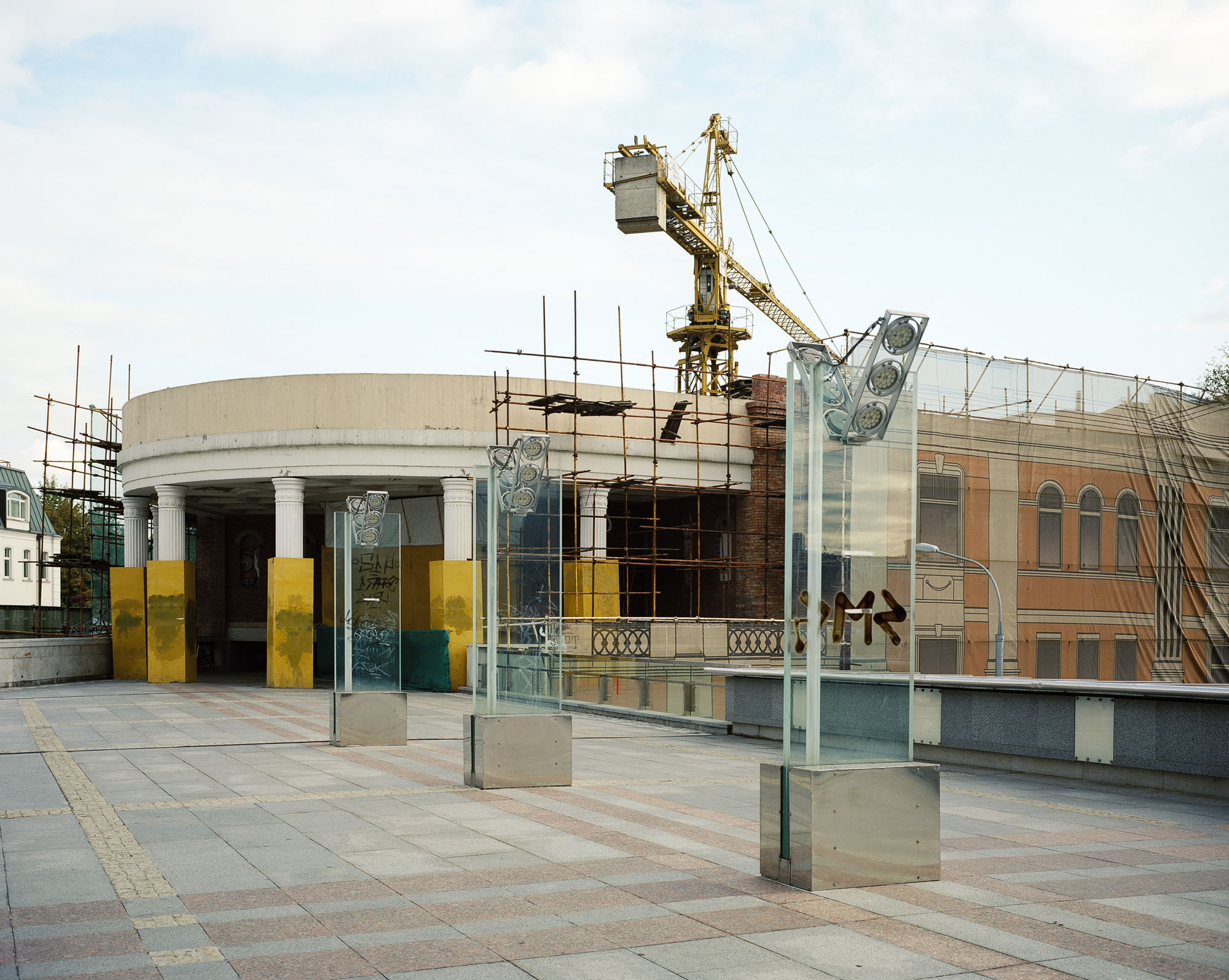 PLATE 36: Lighting posts, barriers, building under construction c/w crane, columns, scaffolding, 	 	printed canvas façade covers