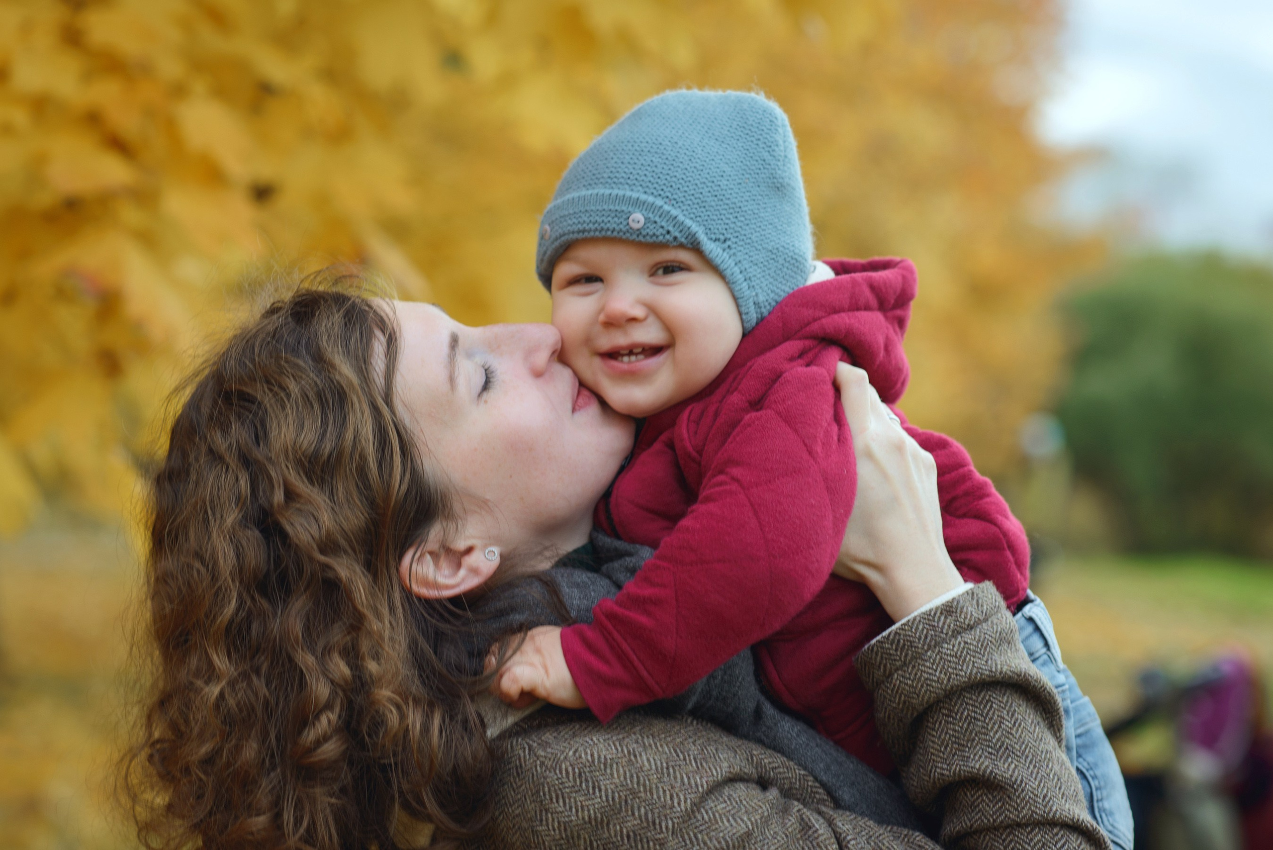 Photo shoot of a mom with baby in autumn. Photos with yellow leaves