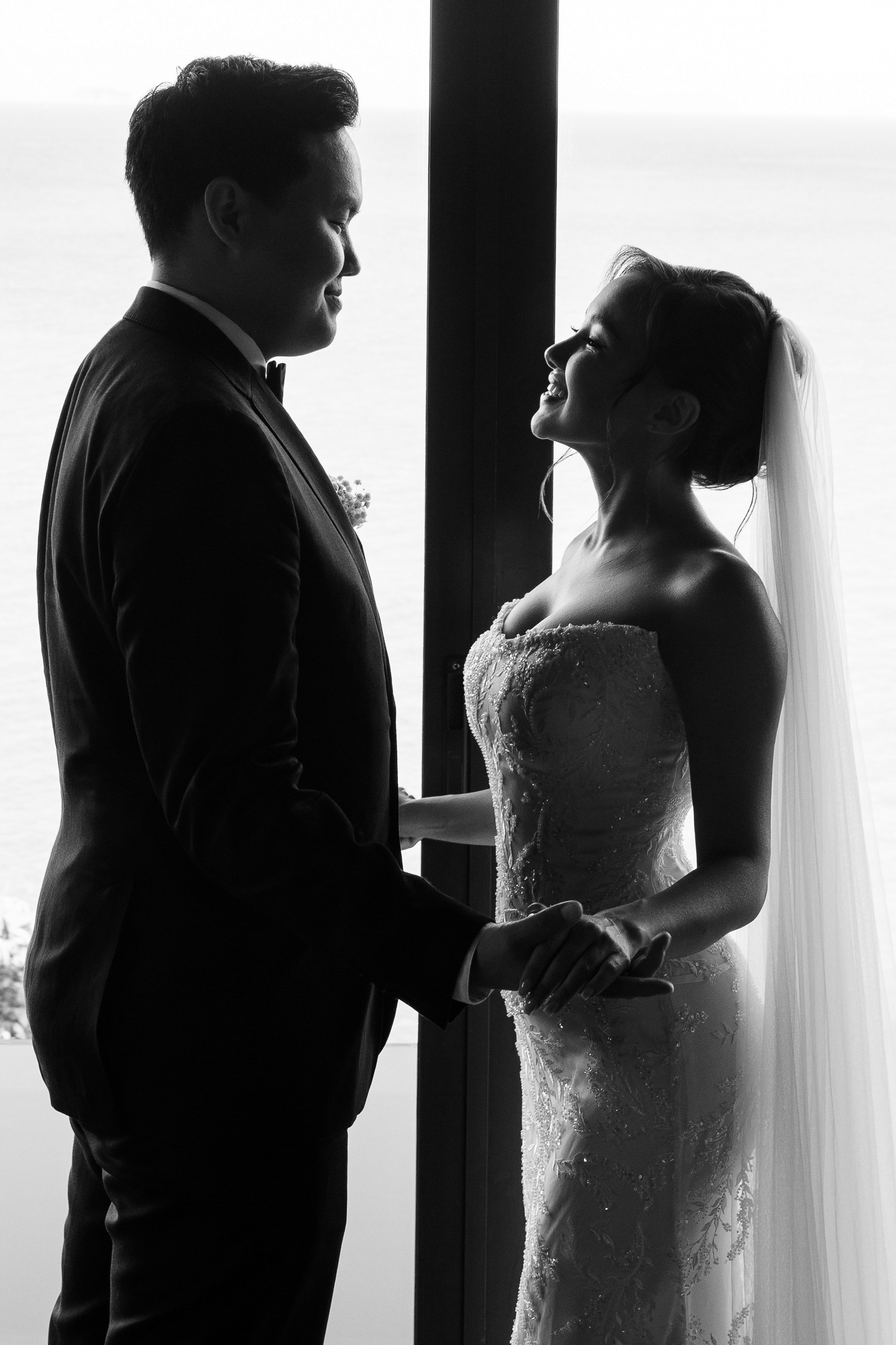 silhouette of a bride and groom at a window
