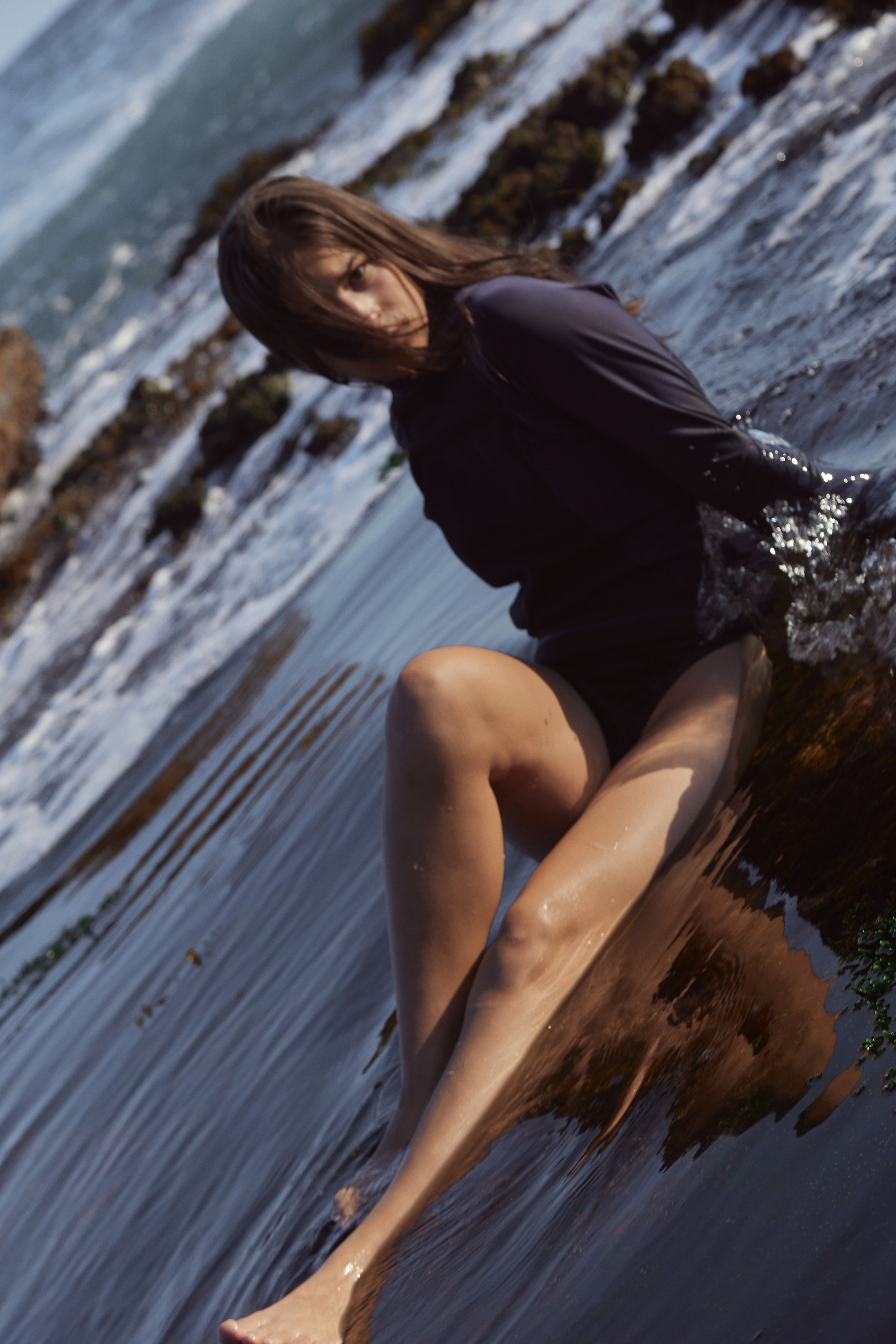 The model and the sea. Swimming suit demonstration.