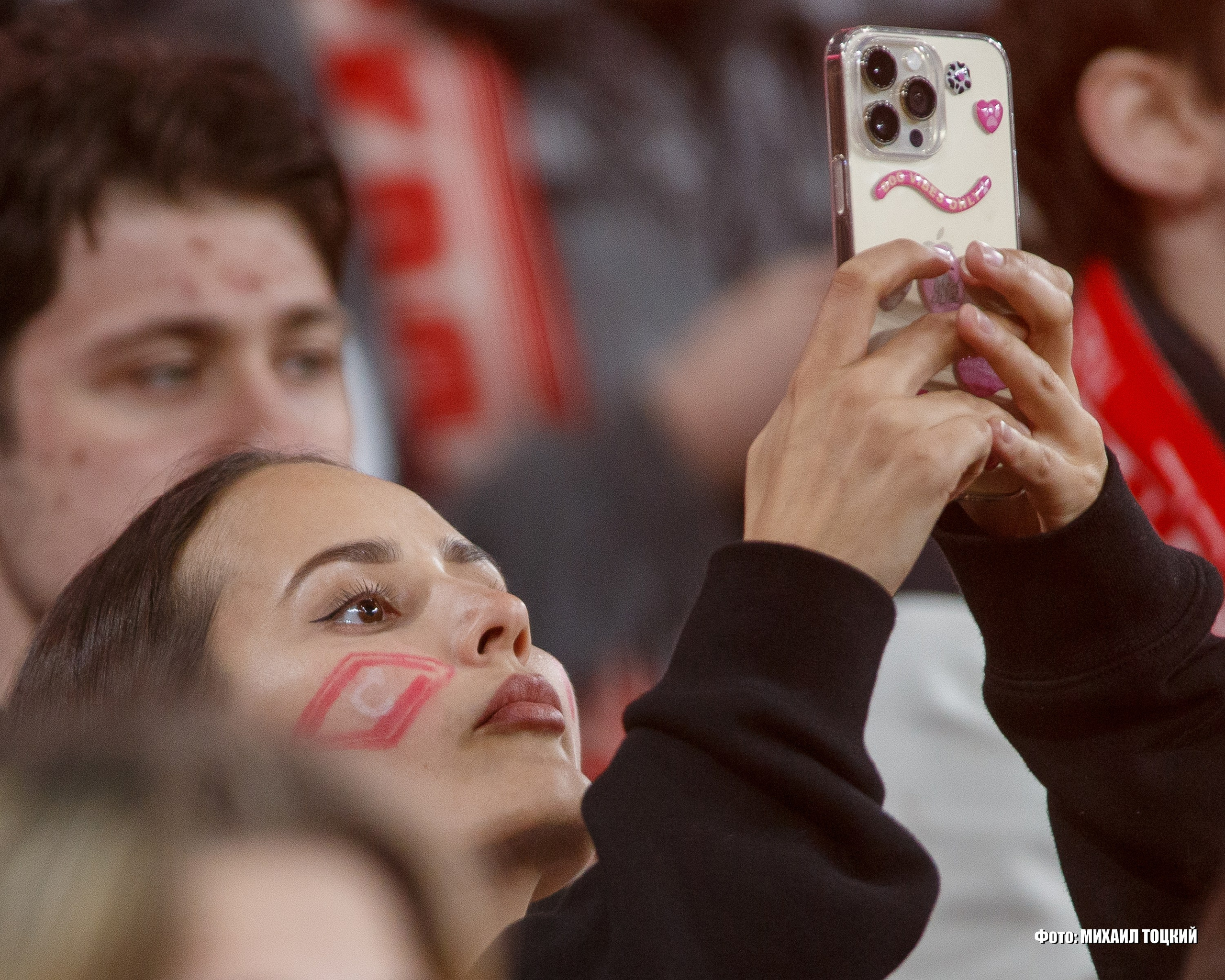 Красивая болельщица с мобильным телефоном Спартака на трибуне Лукойл Арены