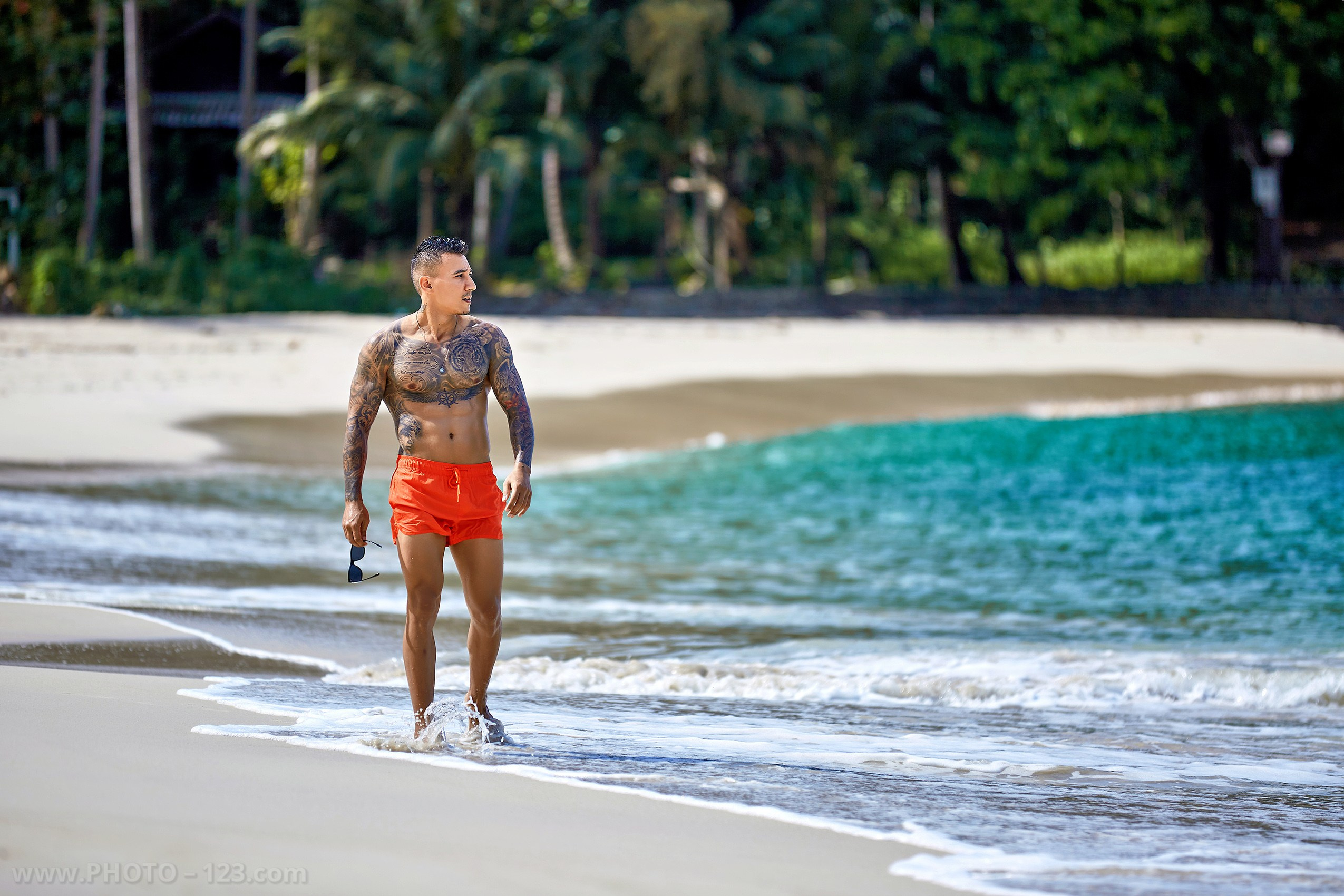 Athletic male model pacing along a tropical beach cove in Nha Trang Vietnam