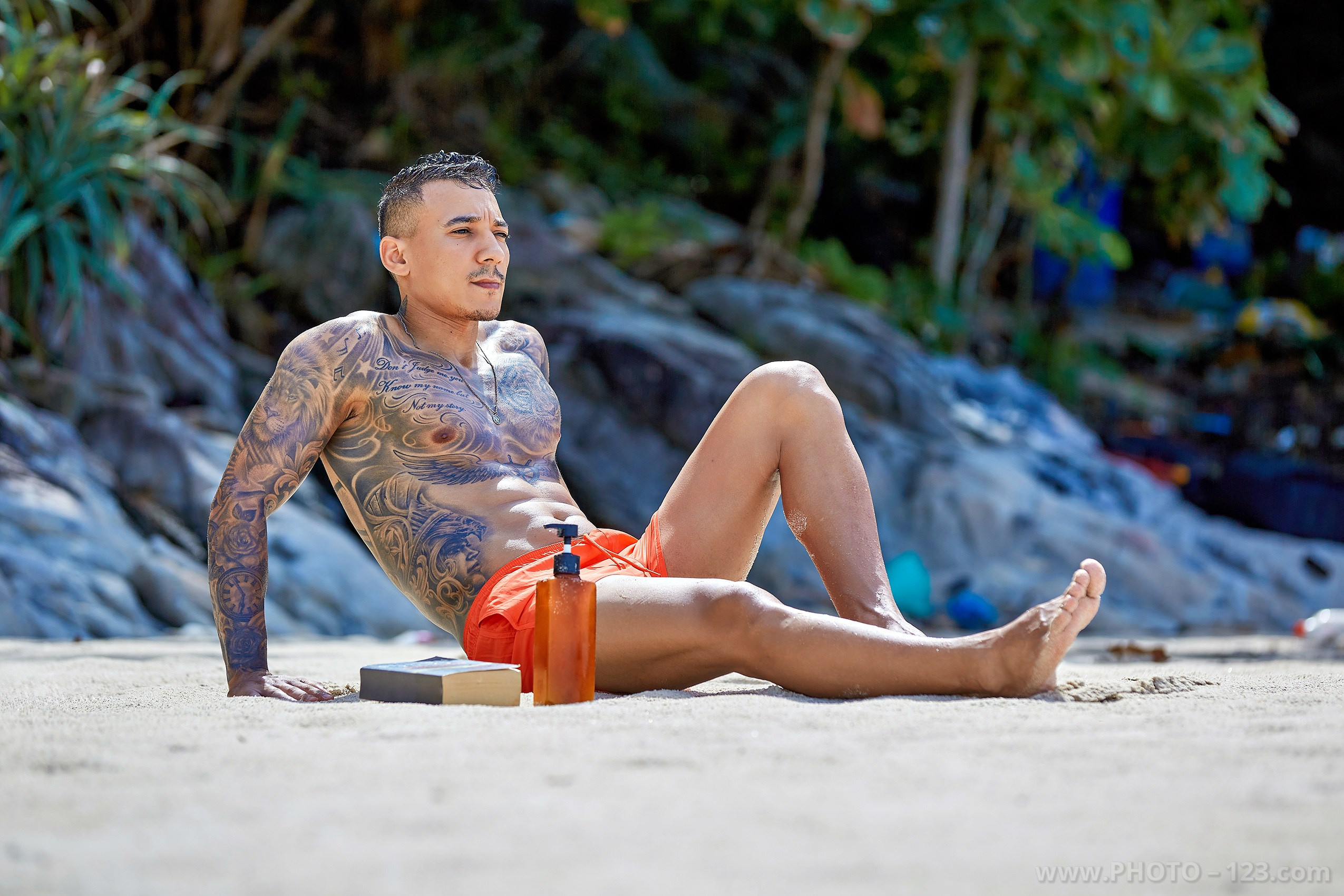 Athletic male model sunbathing on a tropical beach in Nha Trang captured by local photographer
