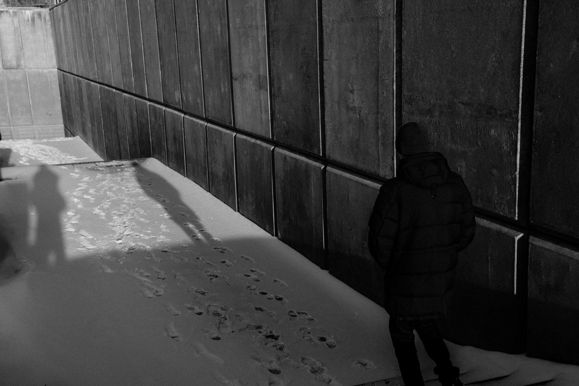 Текстура бетона и следы на снегу в зимнем парке Тюмени. Минималистичная городская среда у набережной реки Тура, контрастный ч/б кадр