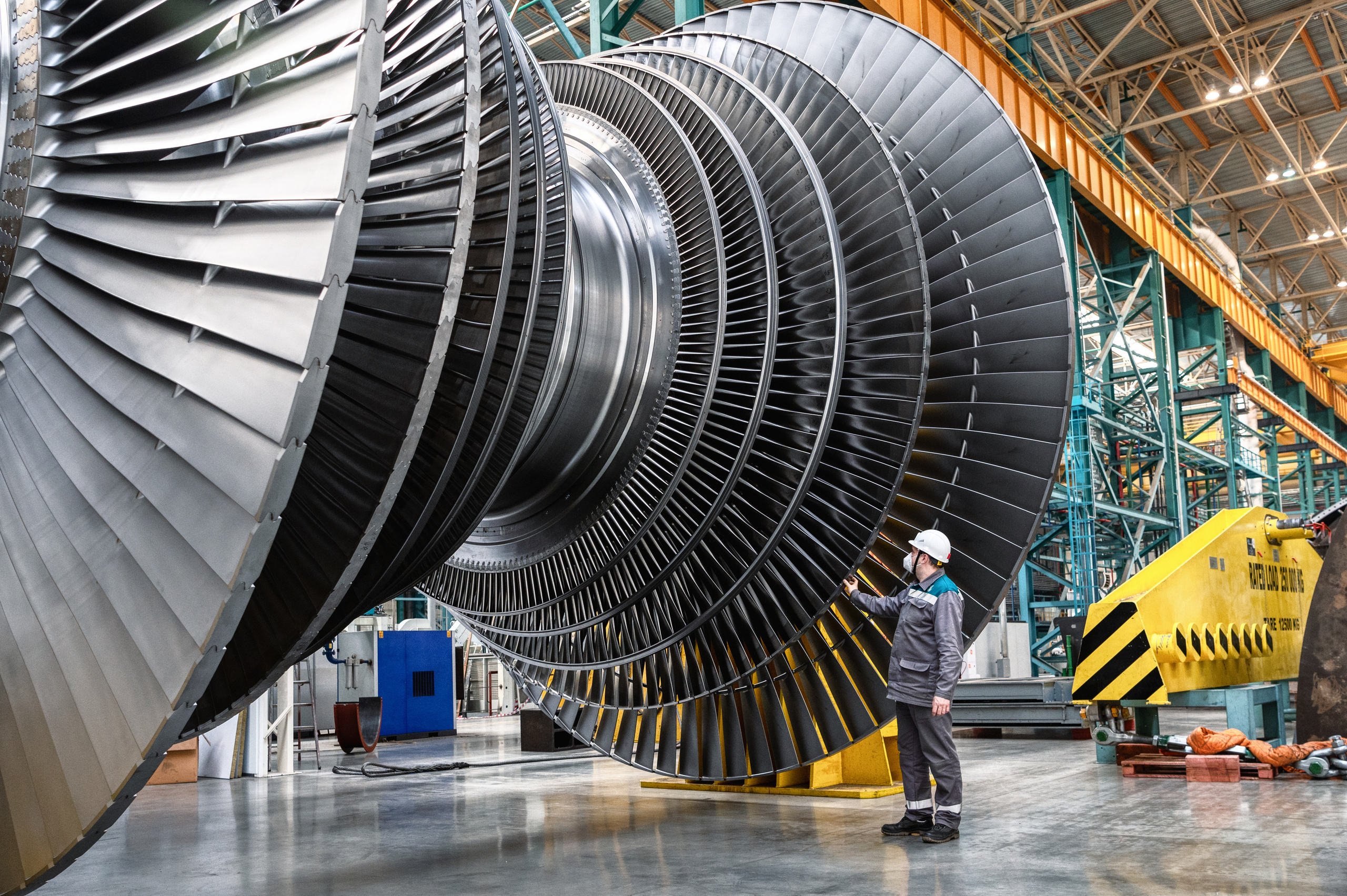 Инженер осматривает лопатки гигантской паровой турбины
