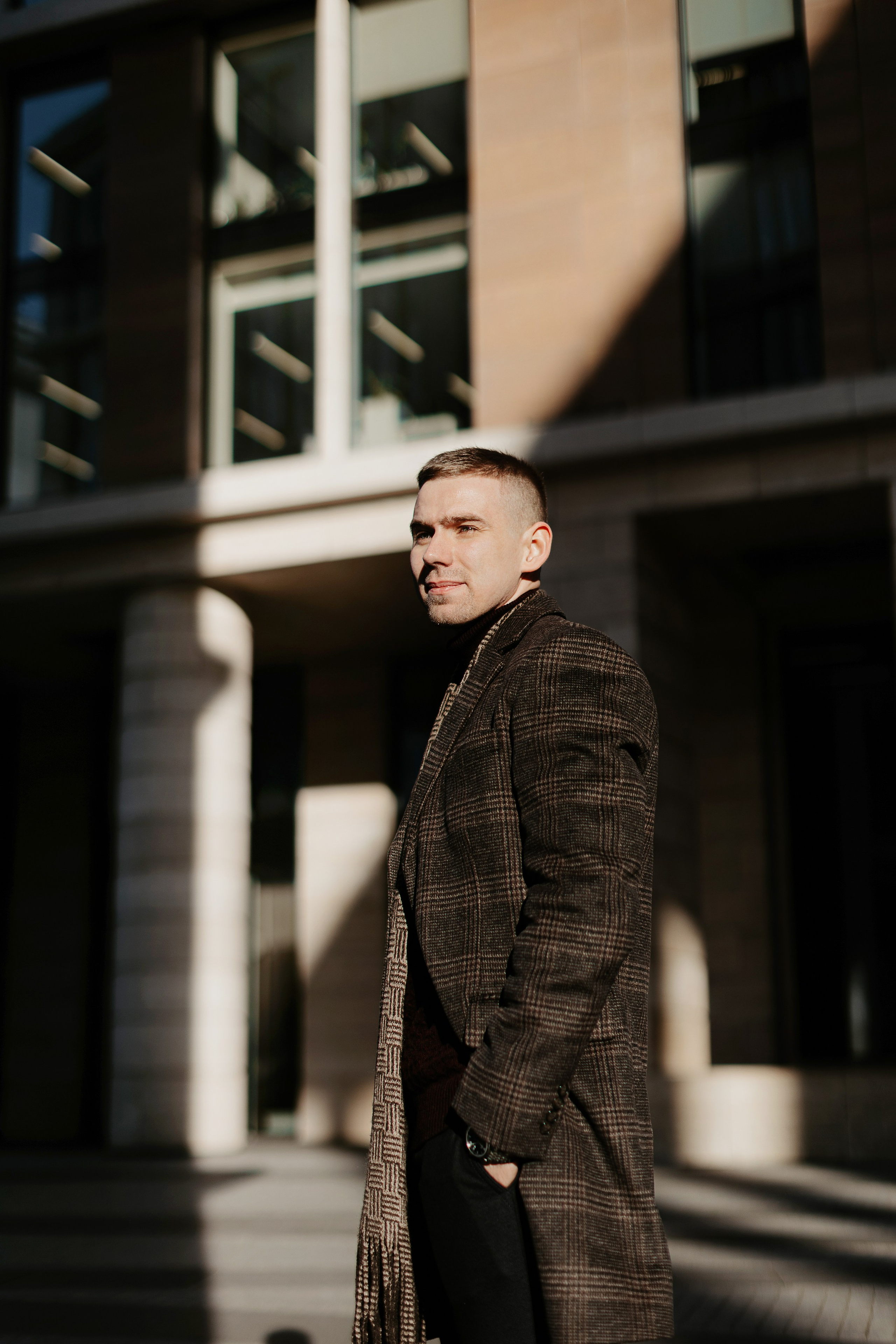 Деловой мужчина в пальто стоит на улице