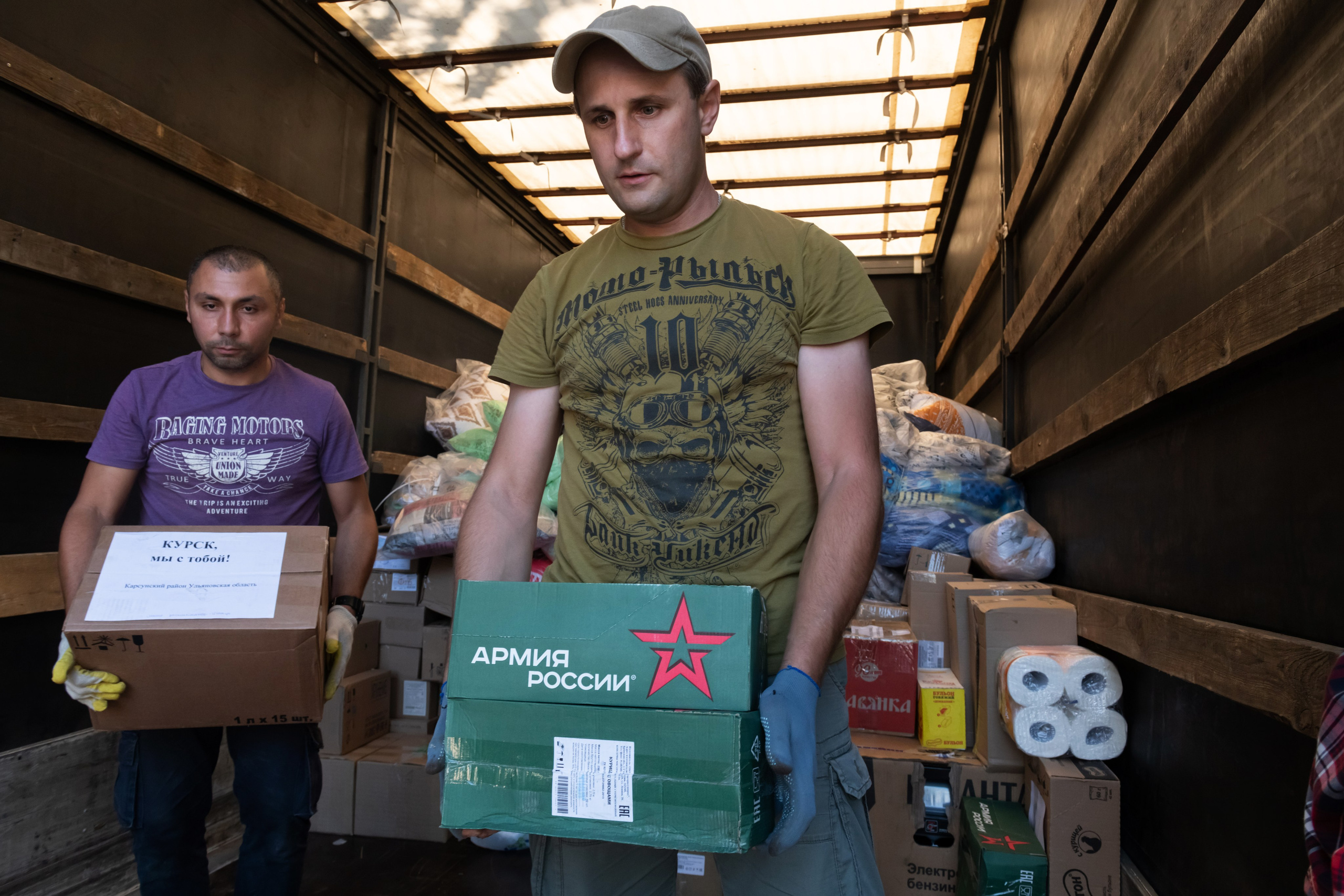 Volunteers unload humanitarian aid to people evacuated from a fighting between Russian and Ukrainian forces in Kursk region, at a temporary residence center in Kursk, Russia, Sunday, Aug. 11, 2024. (AP Photo)