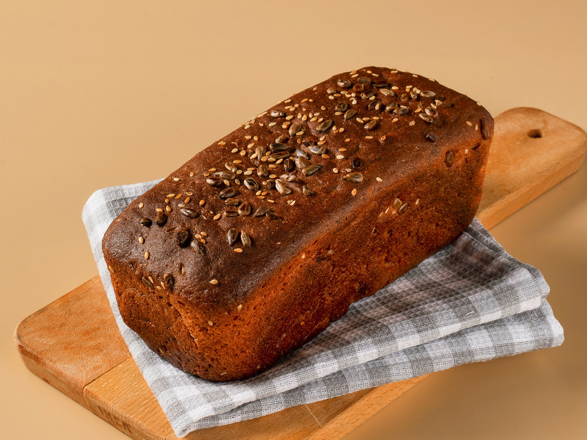 Буханка серого хлеба с семенами кунжута и подсолнечника