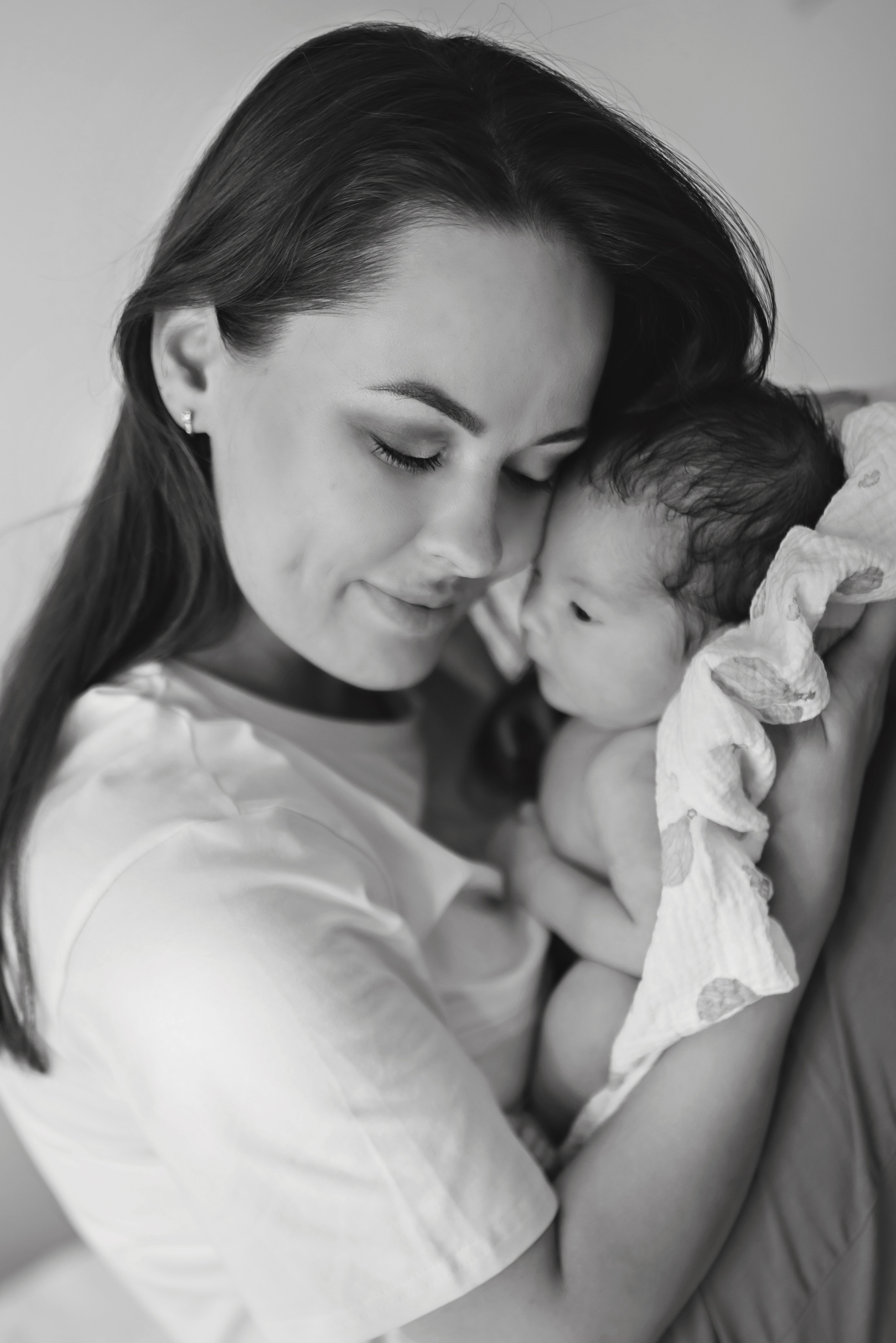 Natural light photo of a mother holding her baby for the first time