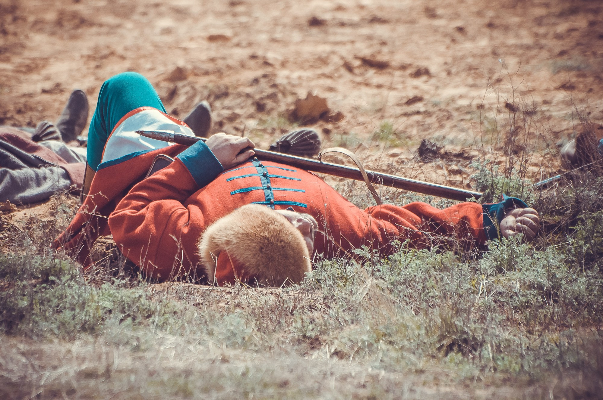 Участник реконструкции лежит на земле