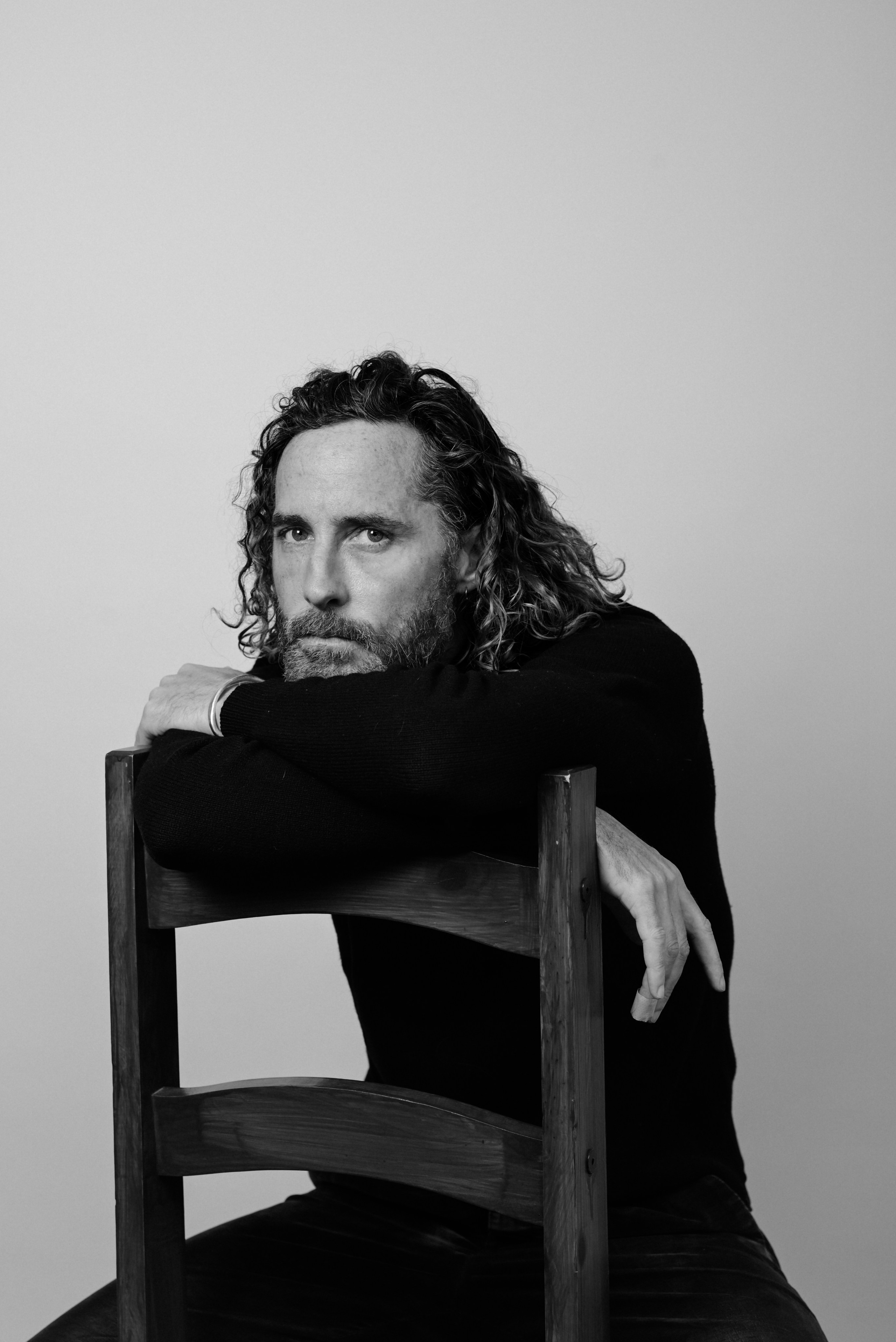 model portfolio photoshoot in london - male model in black and white seated