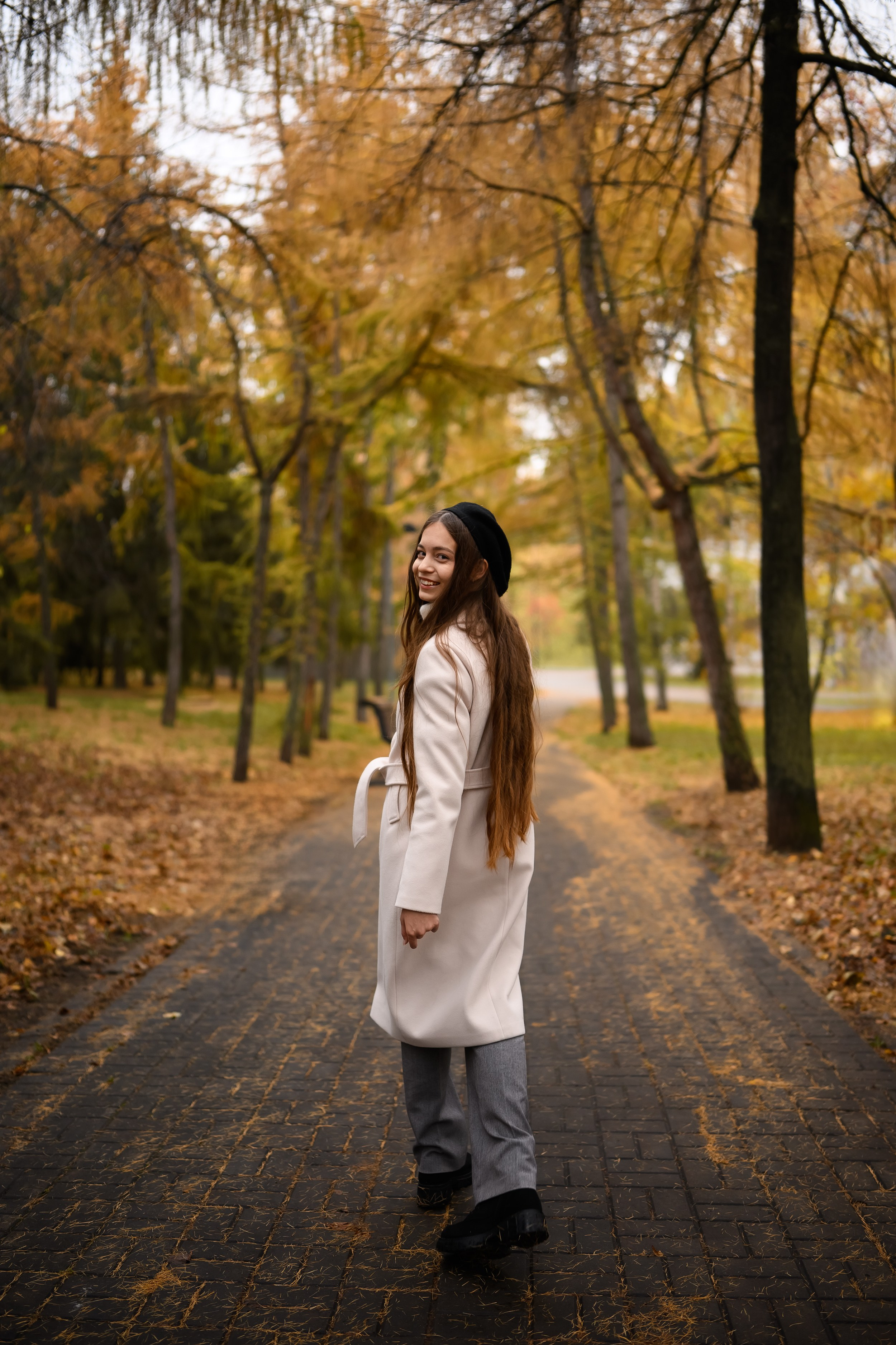Осенний портрет девушки в парке Казани в белом пальто от профессионального фотографа