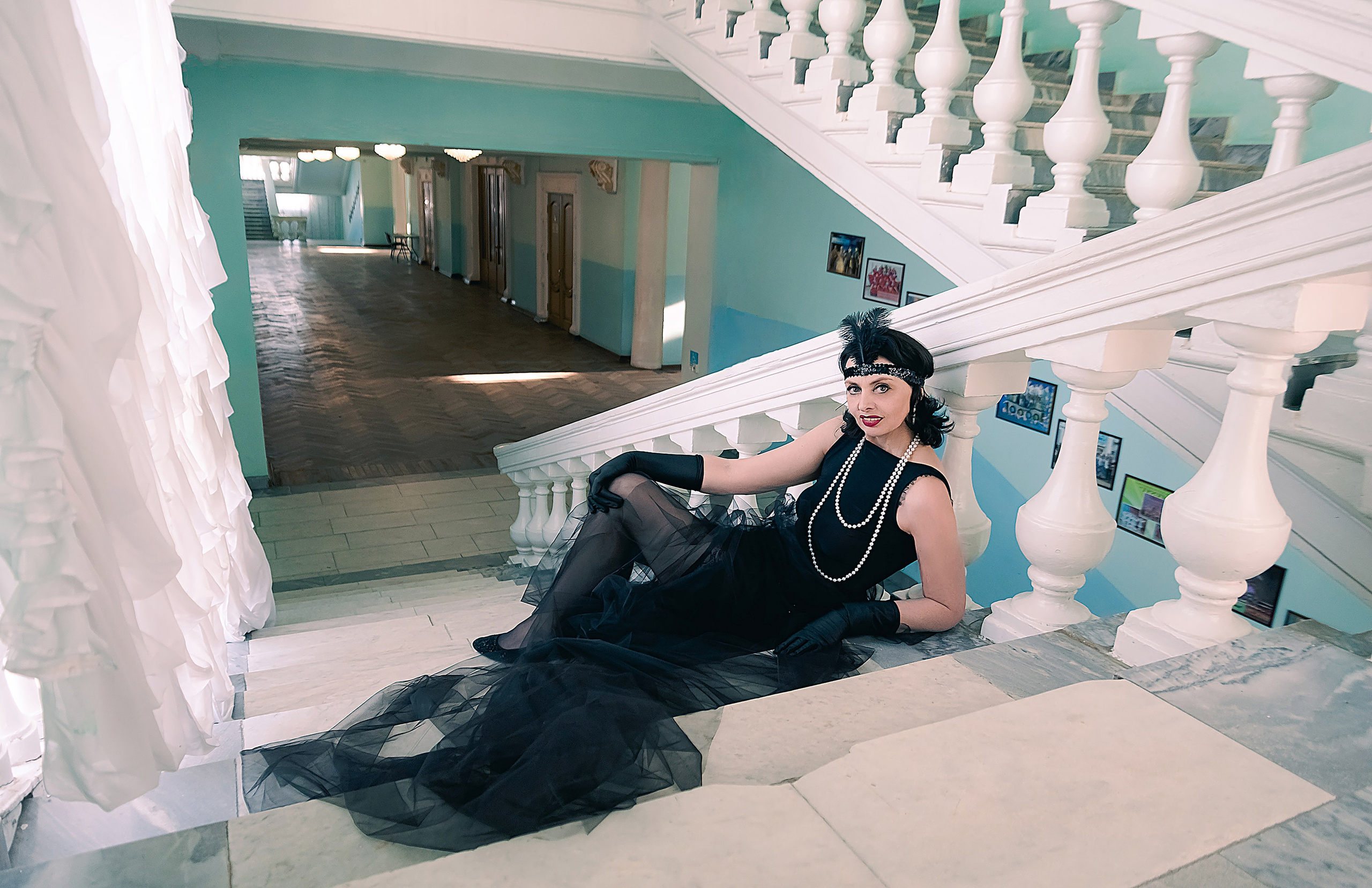 Девушка в стиле ретро, винтаж, Гэтсби на лестнице смотрит в окно.