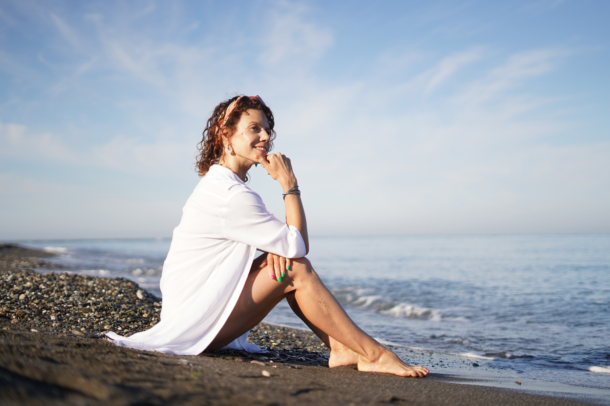 Девушка в купальнике сидит на пляже в Сочи