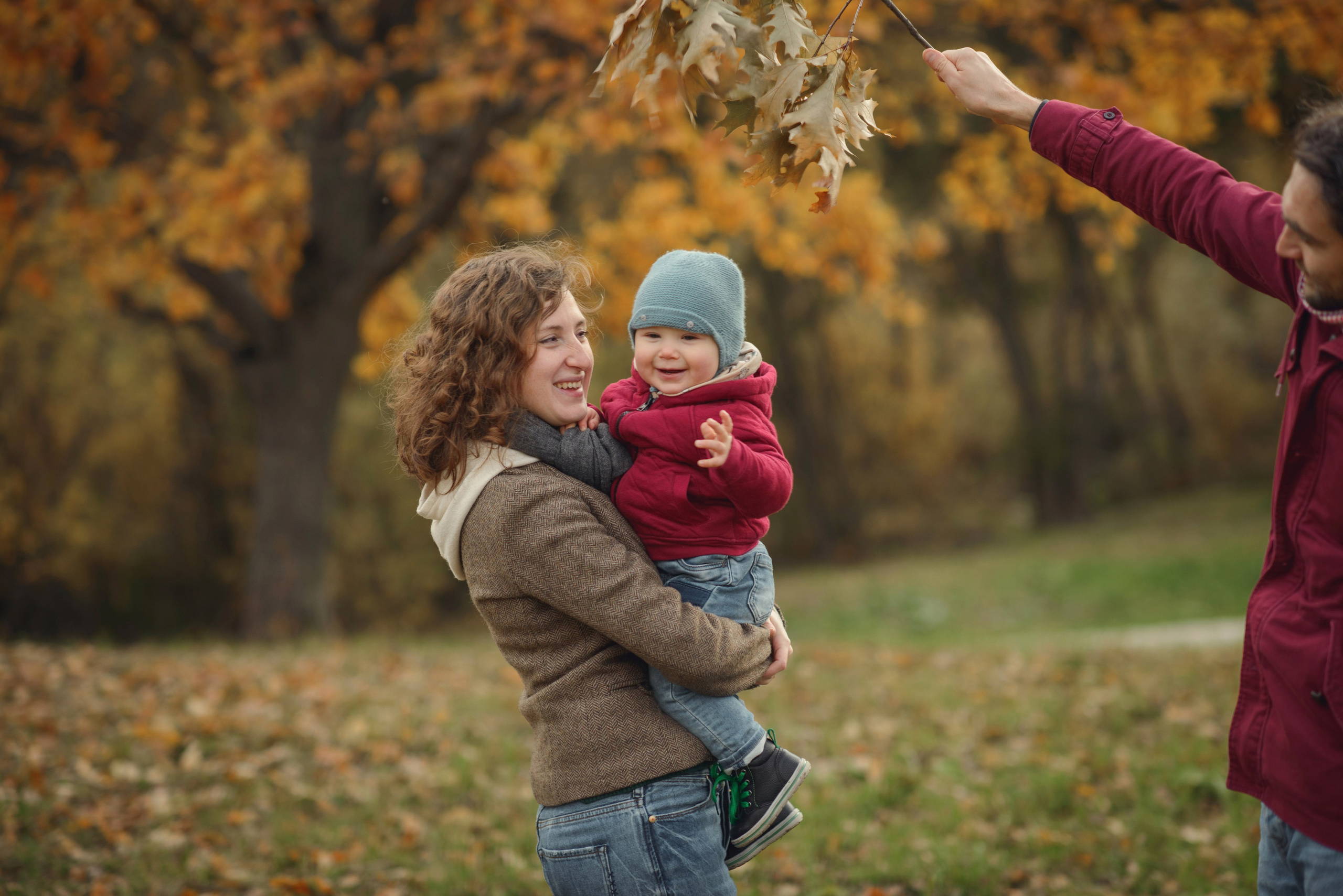 Photo shoot of a mom with baby in autumn. Photos with yellow leaves