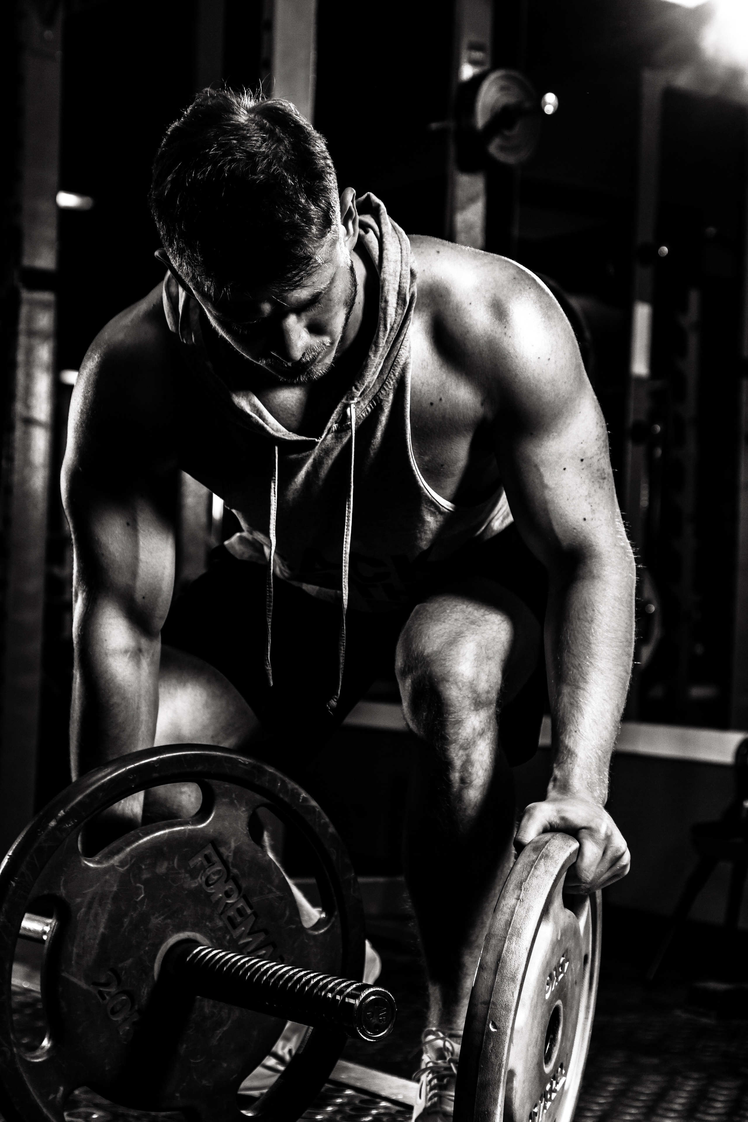 Профессиональная фитнес спортивная фотосессия спортсмена тренера со штангой в тренажерном зале в Москве.