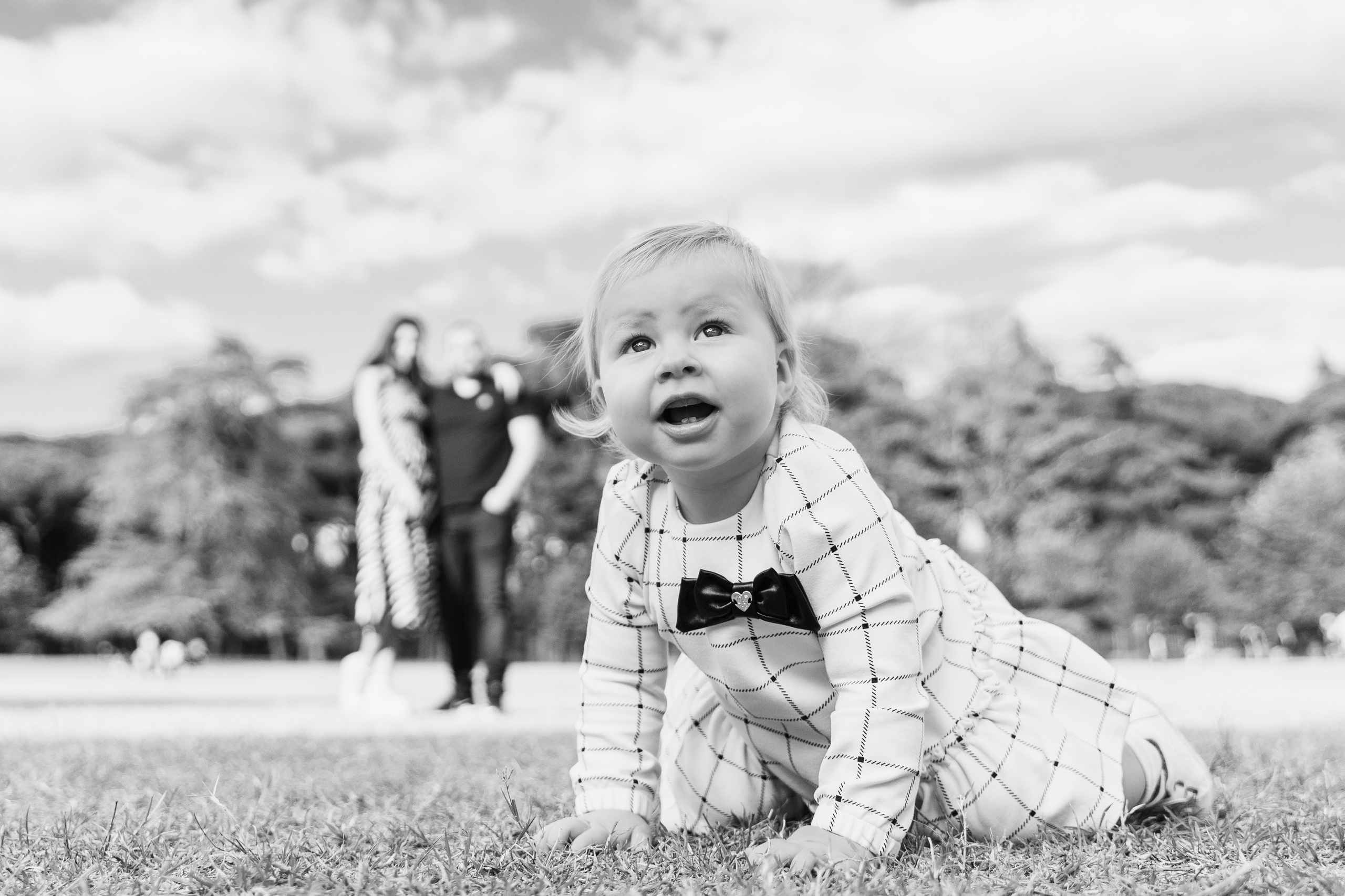The child playing in the town's lovely park during a family walk in Montecatini.