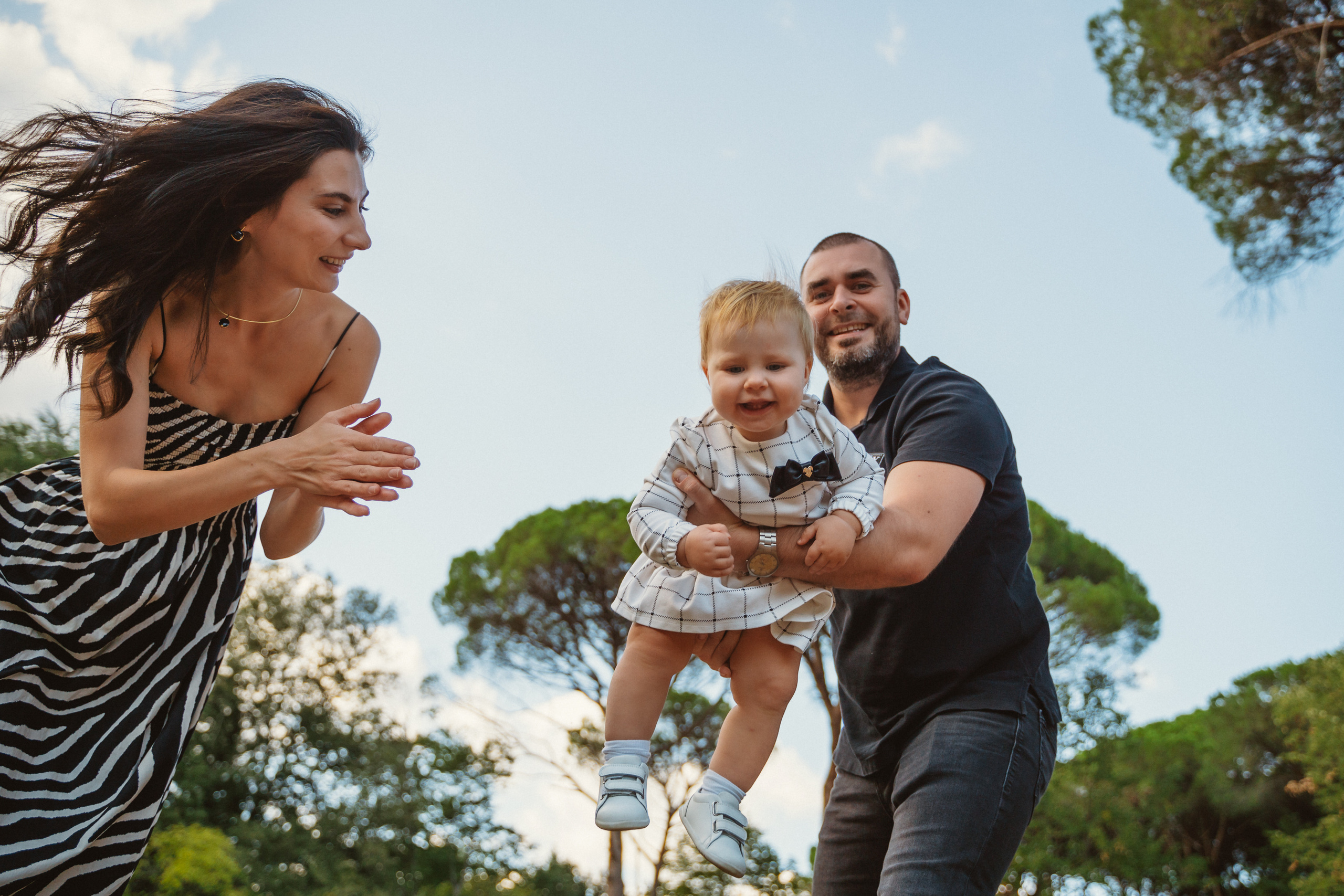 Smiling family members enjoying a sunny day while walking in Montecatini
