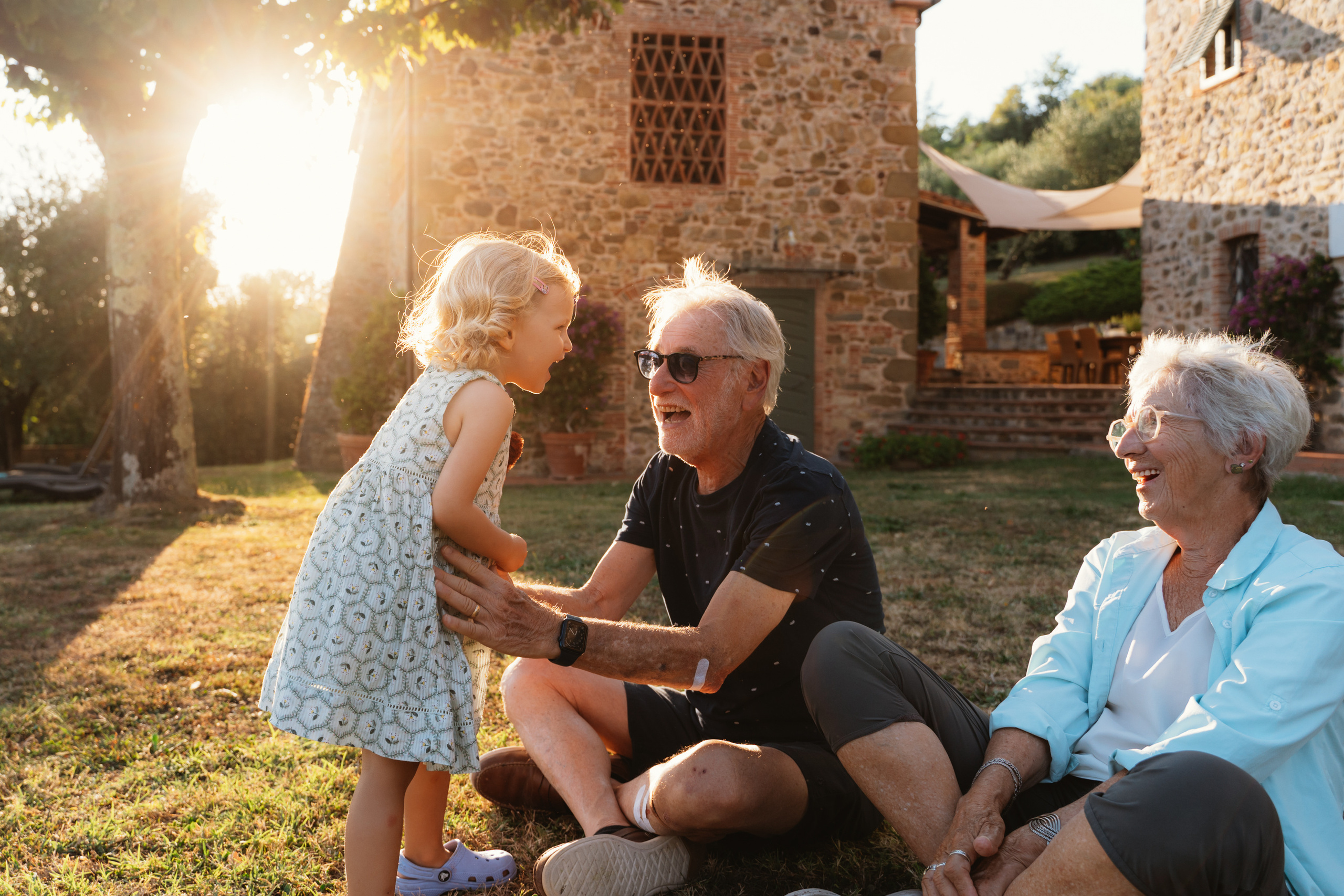 Grandmothers and grandfather sharing a heartfelt moment with their grandchildren in Tuscany.