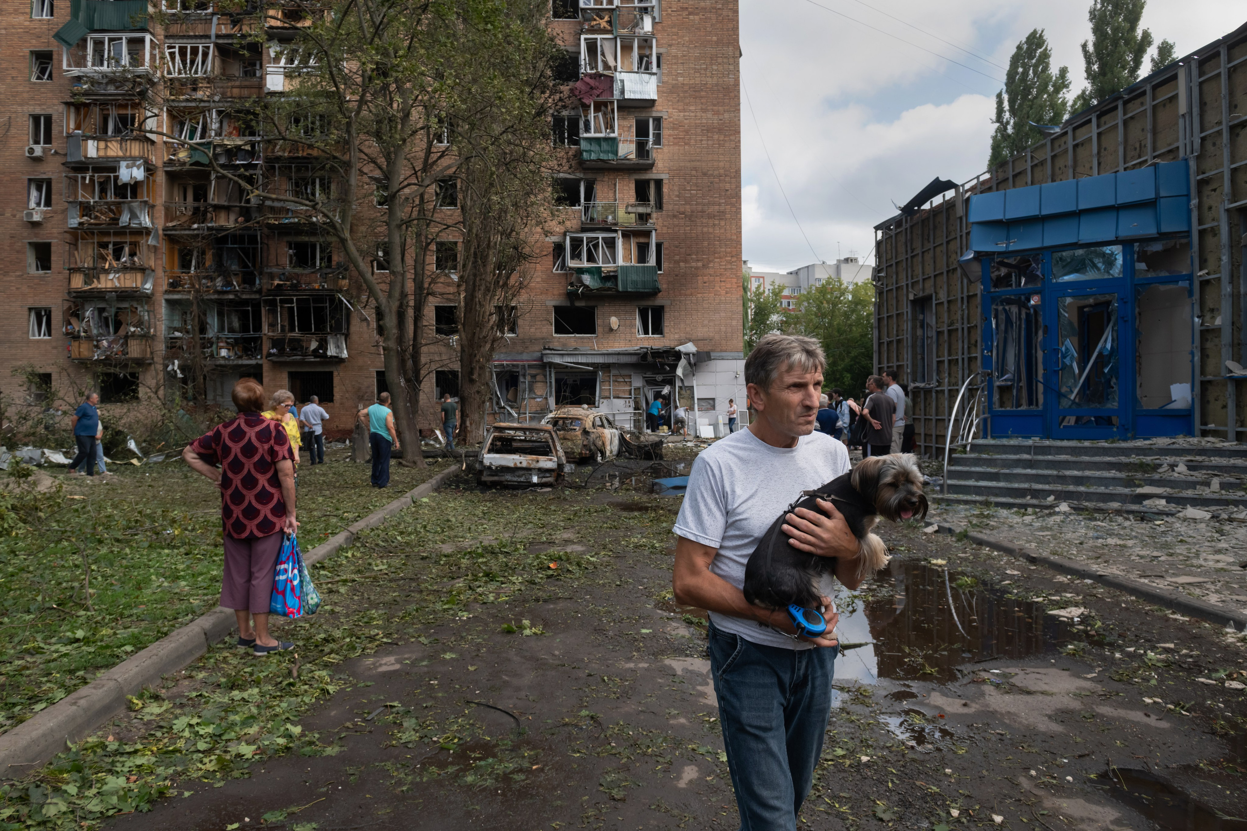 Residents of an apartment building damaged after shelling by the Ukrainian side leave the area in Kursk, Russia, Sunday, Aug. 11, 2024. (AP Photo)