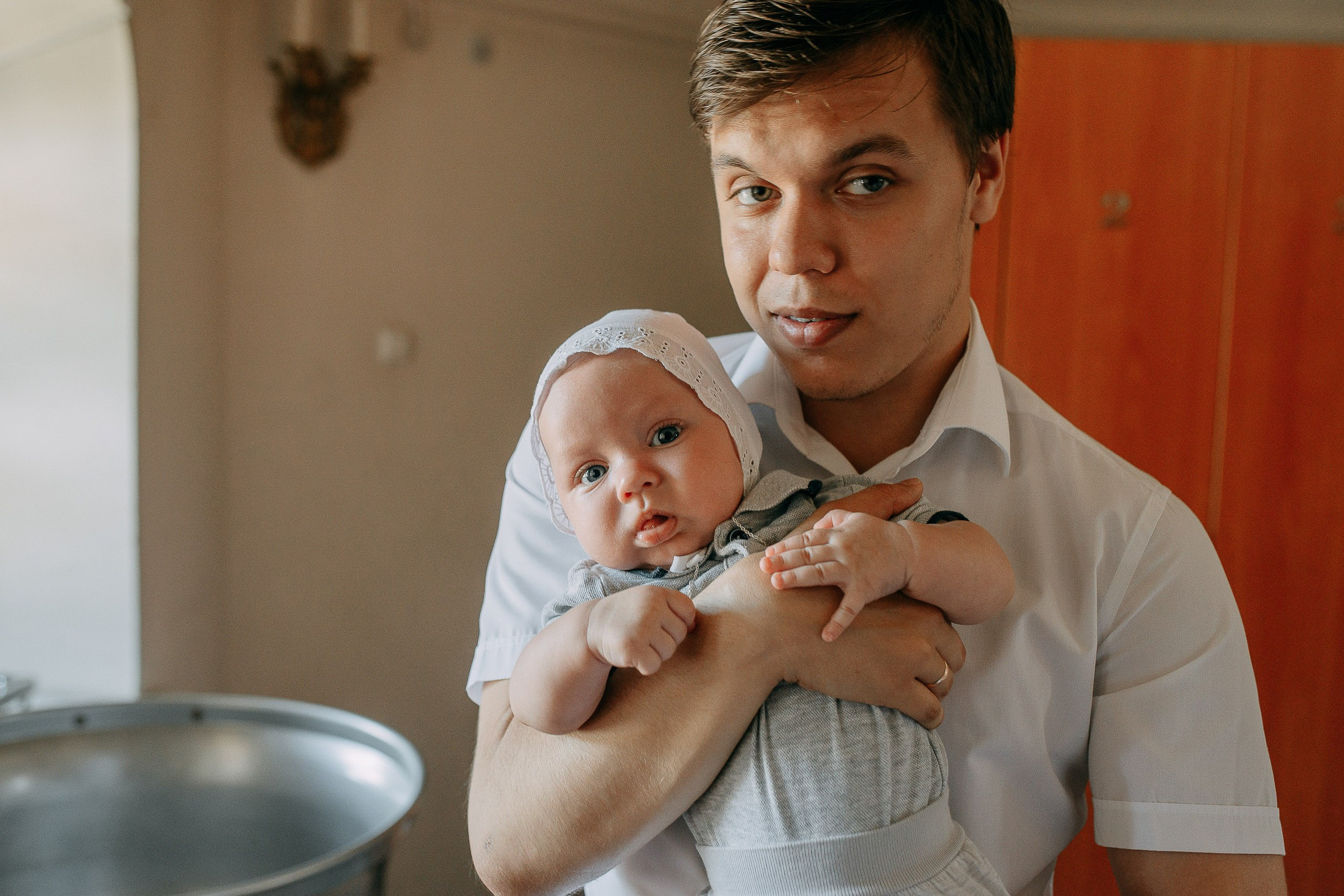 Семейный фотограф, профессиональный портрет папы с грудным ребенком в церкви.