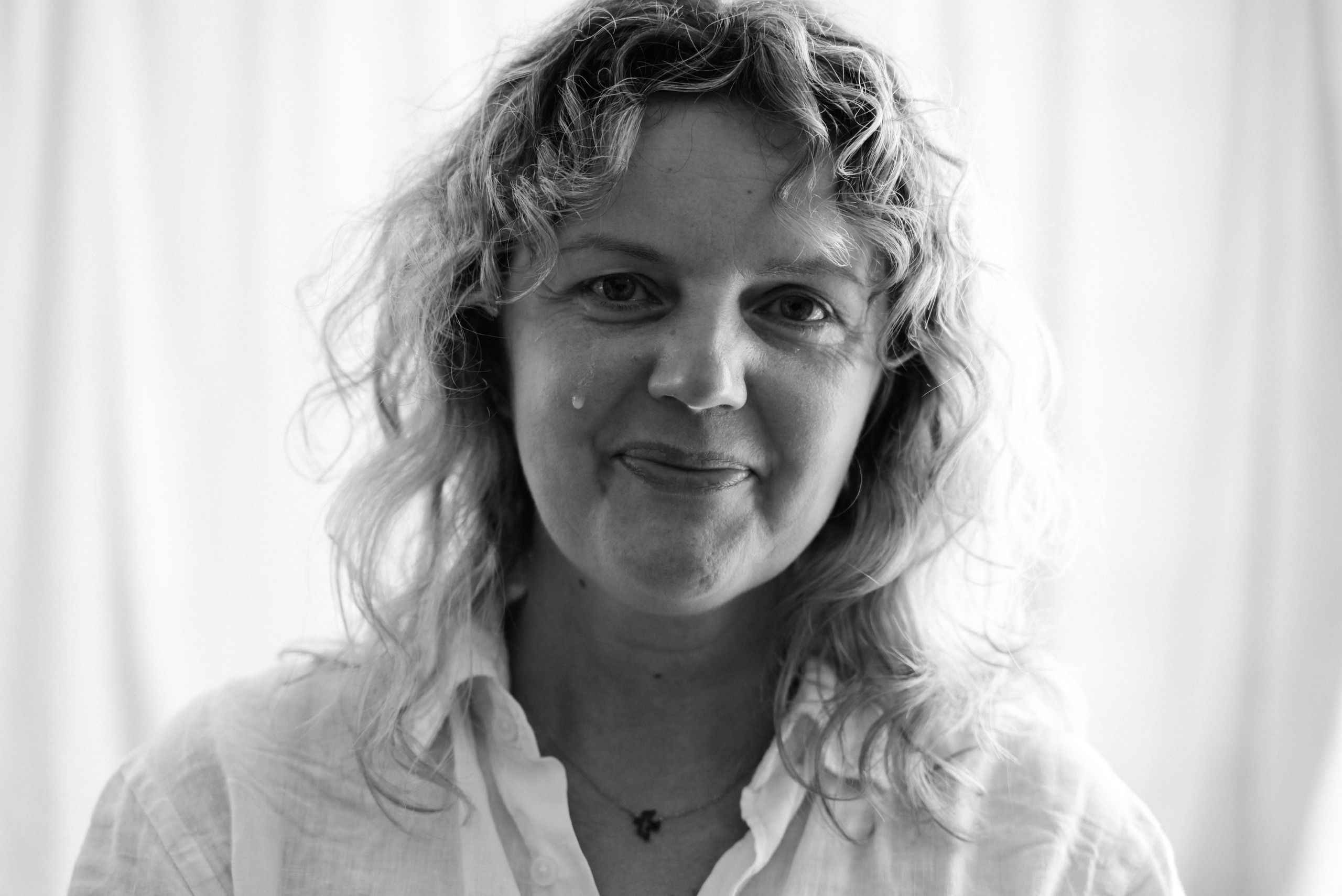 portrait of woman smiling naturally and crying