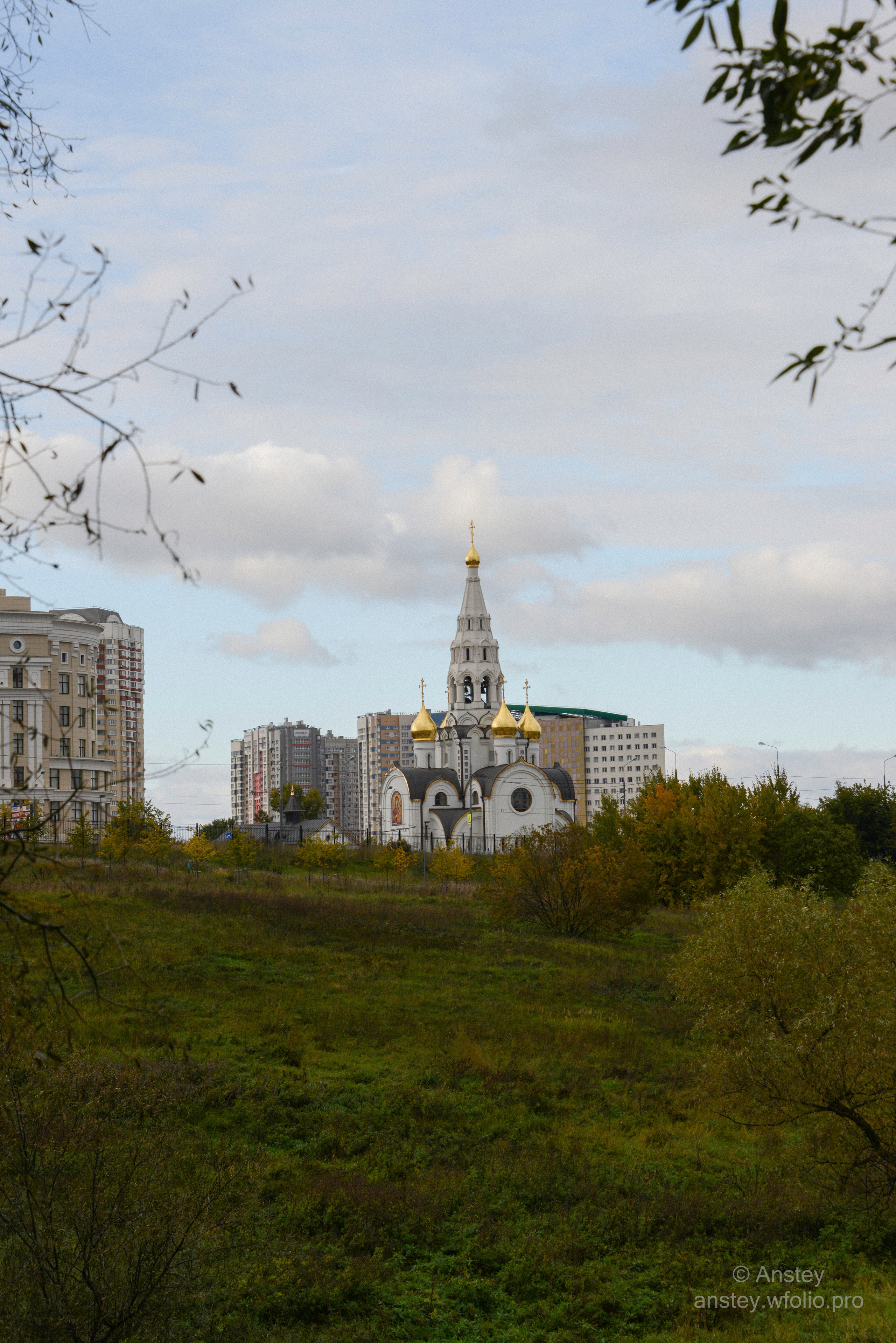 View of Russian Orthodox Christian church against cloudy sky in early autumn.