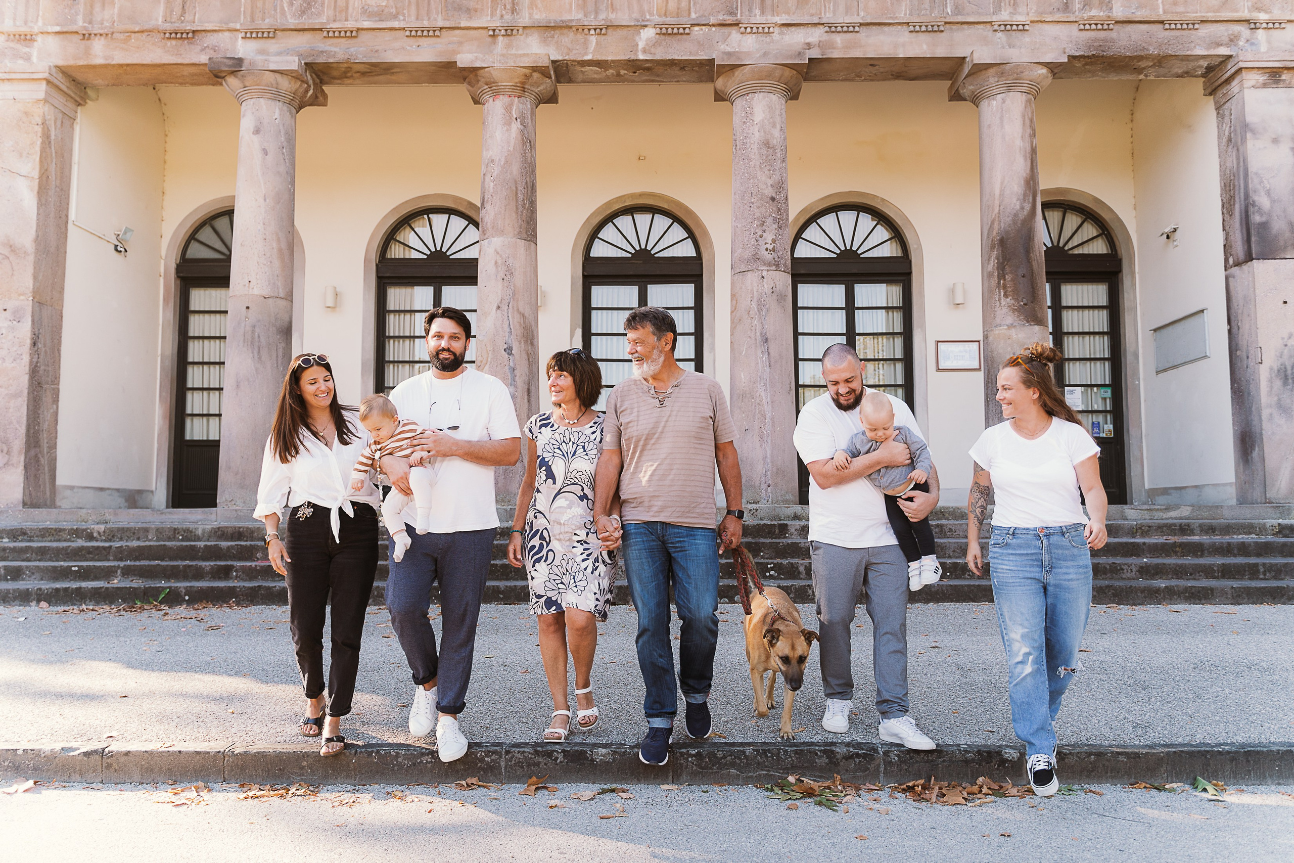 The family admiring the medieval architecture and picturesque scenery in Lucca, Tuscany.