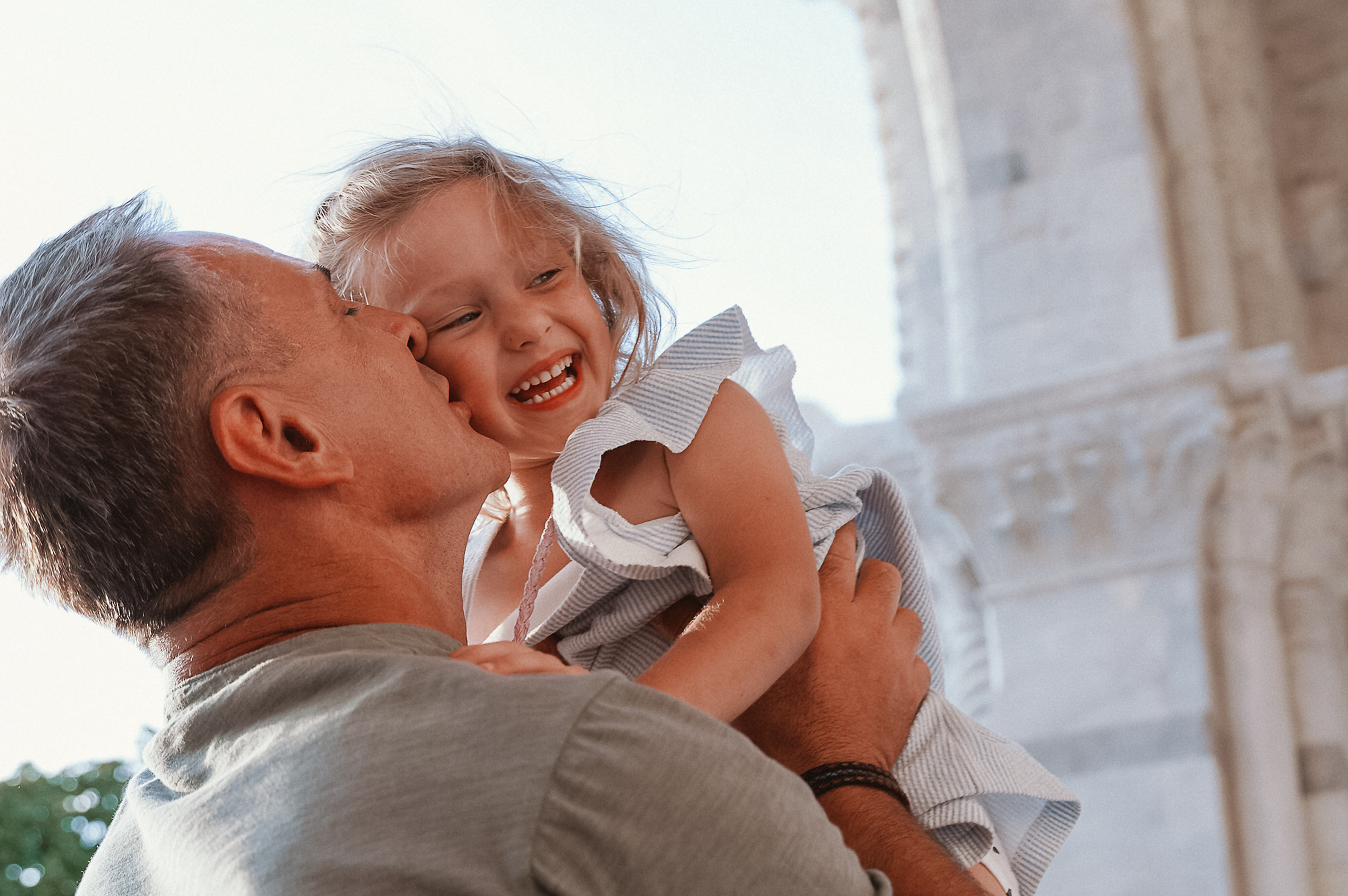 Dad embrace while his small daughter