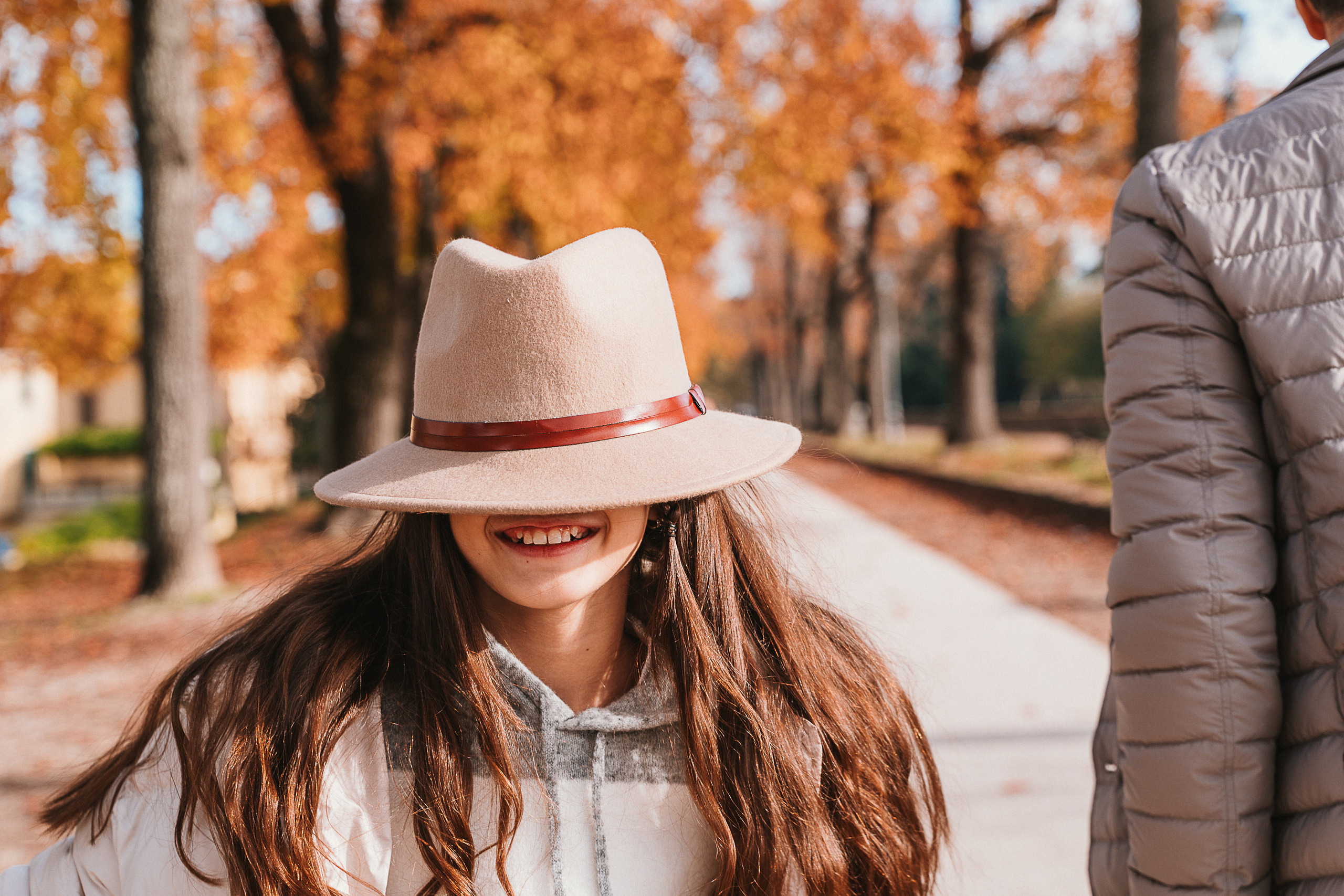 Parents and children walking hand in hand as they explore the historic city of Lucca.