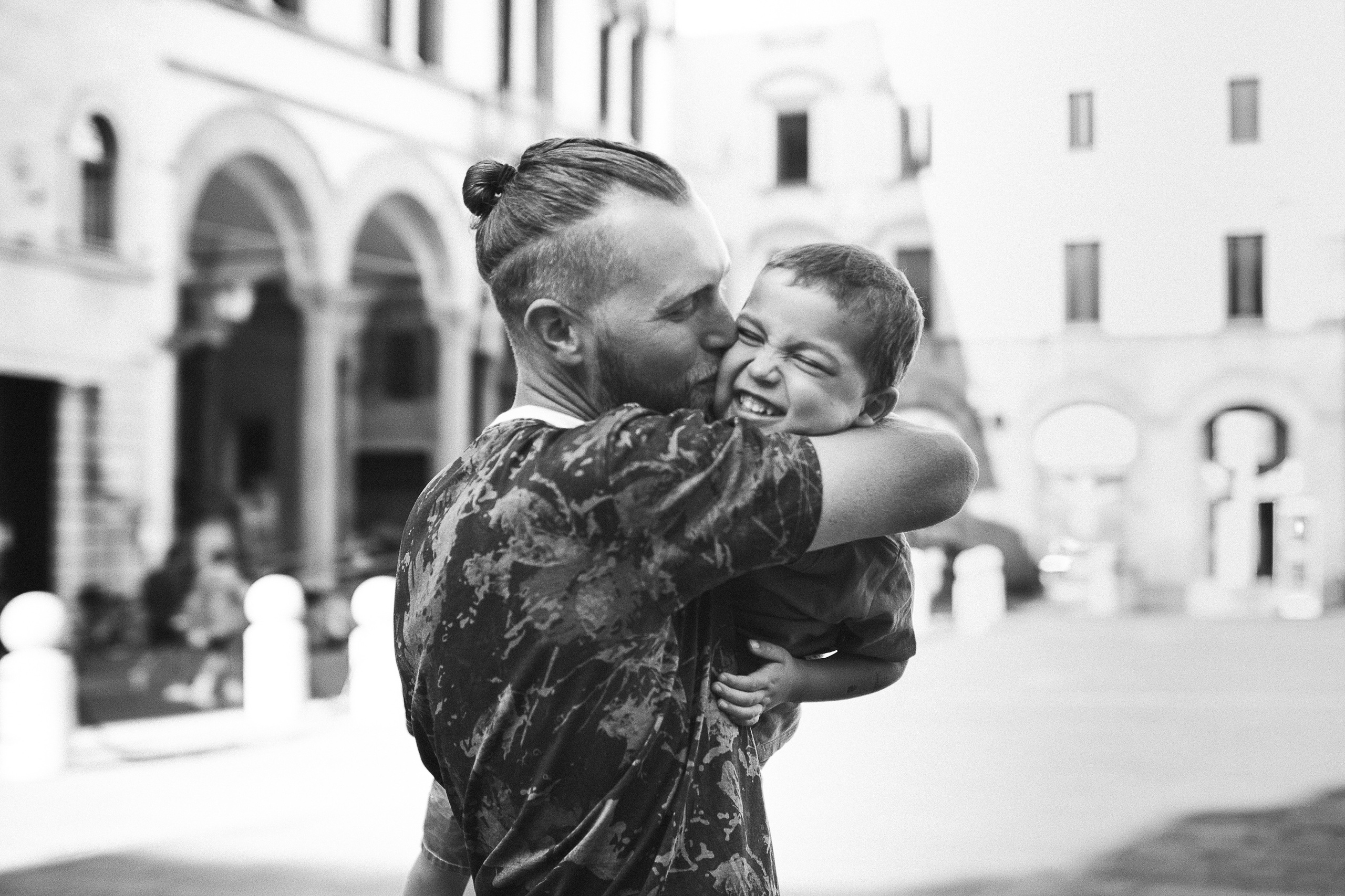 Parents and children walking hand in hand as they explore the historic city of Lucca.