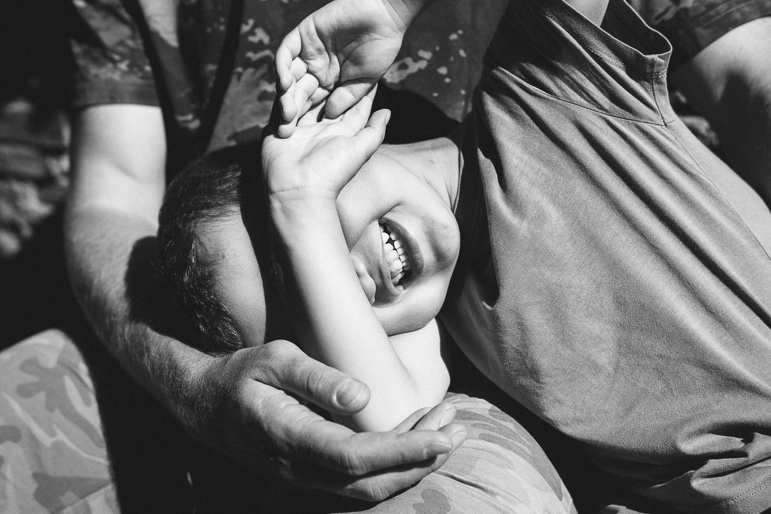 A close-up of the children's joyful expressions as they with parents in Tuscany walk in Lucca