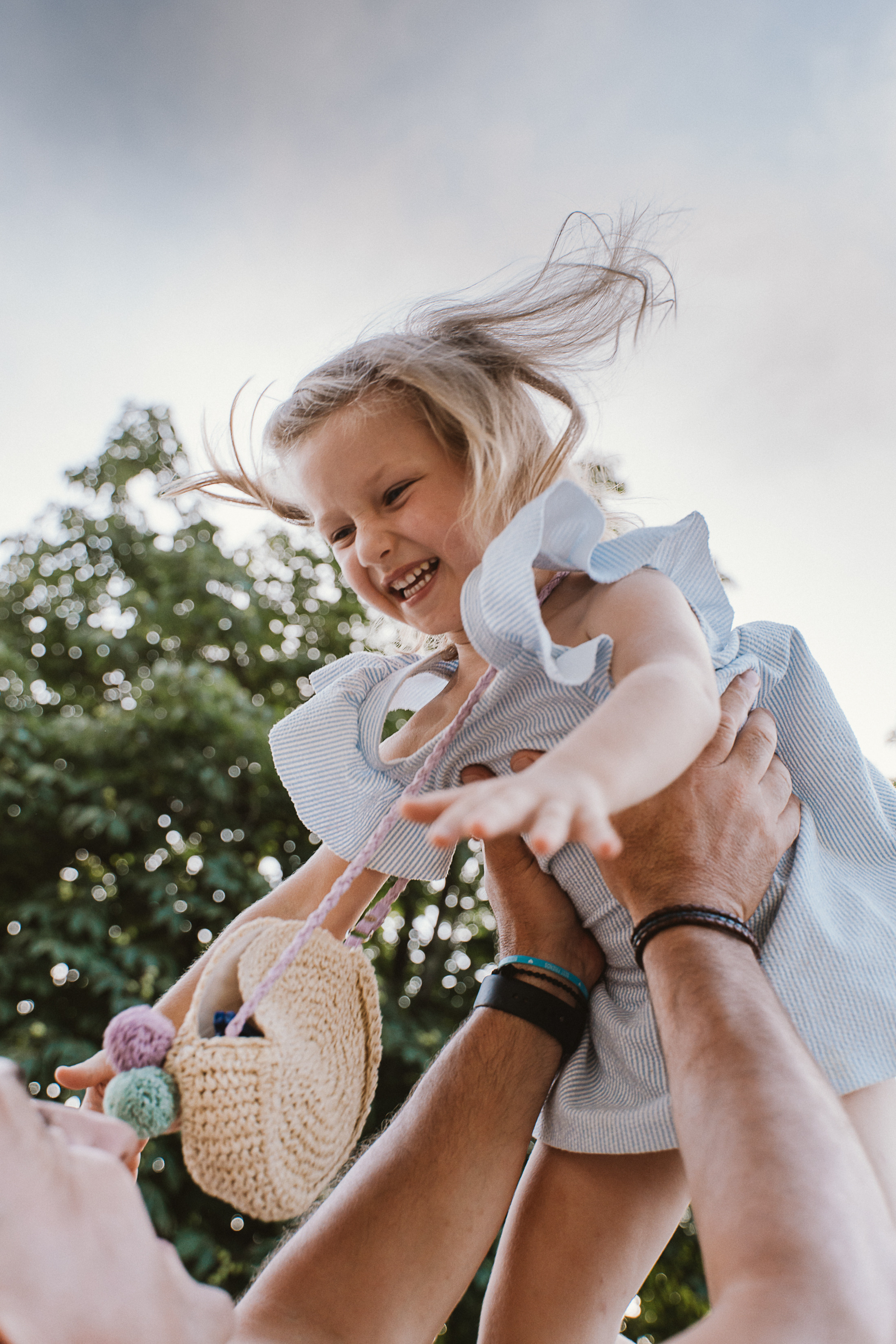 A happy family of four smiles under the Tuscan sun