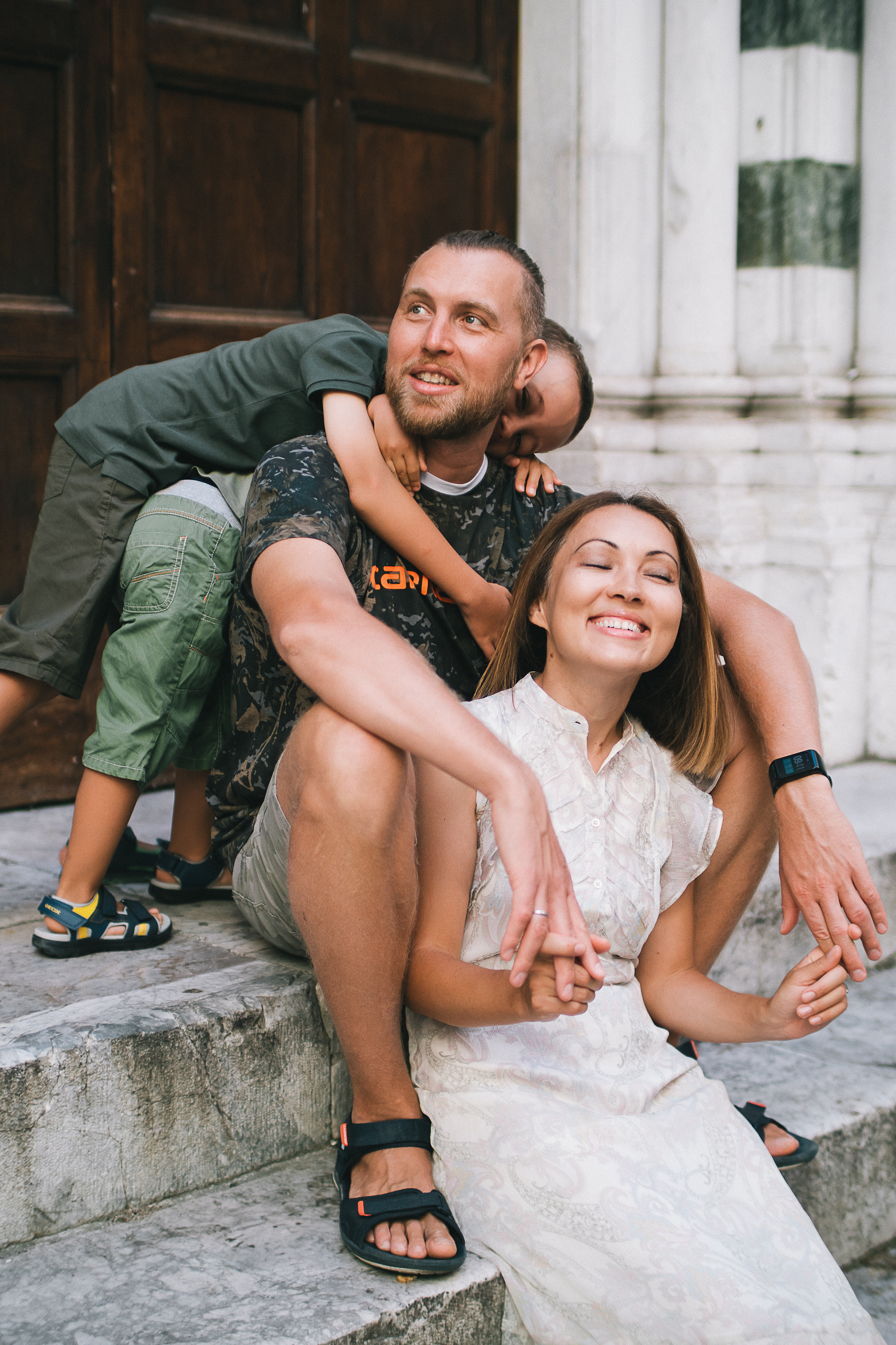 happy family taking a leisurely walk through the charming streets of Lucca, Italy.