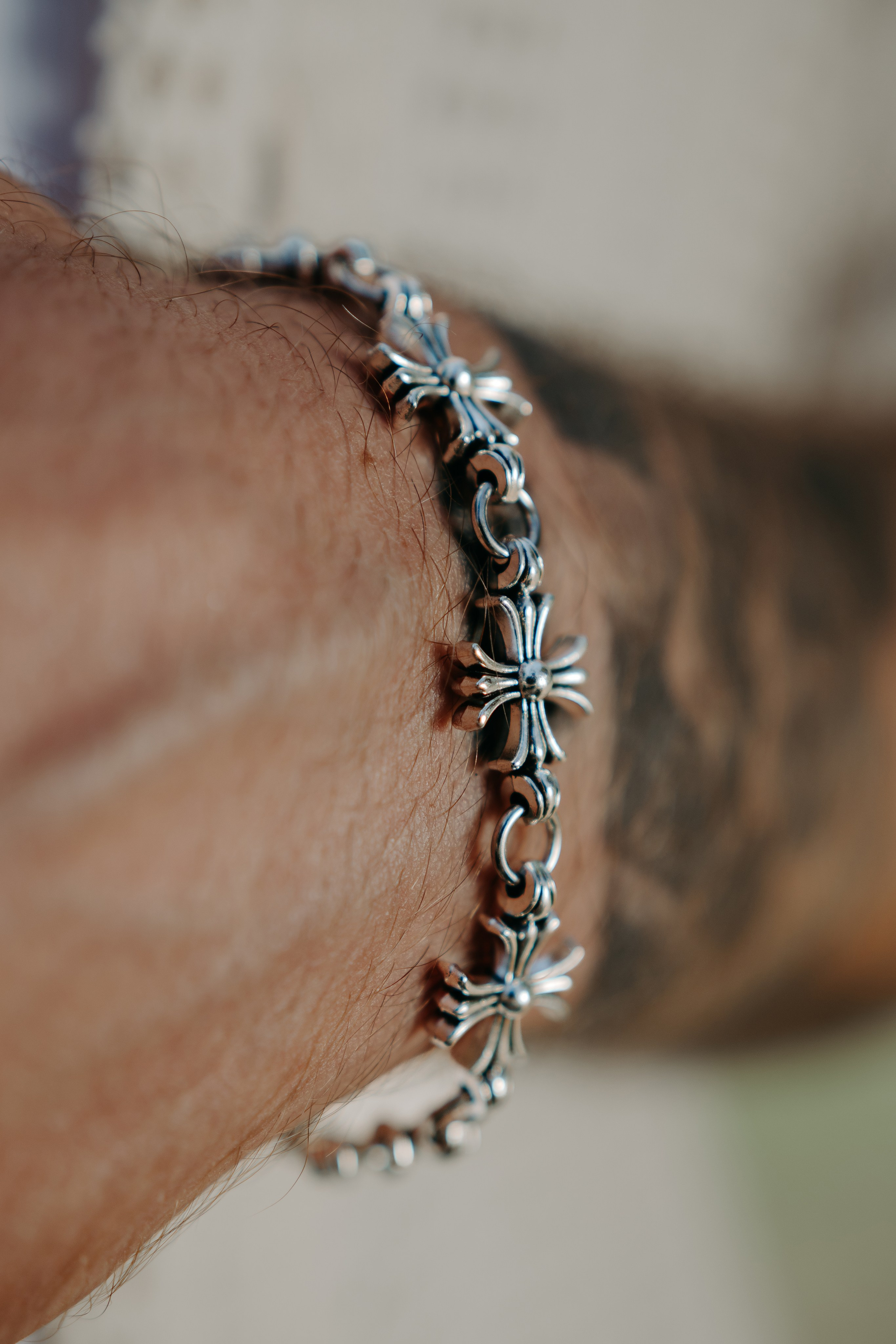 Close-up of a sun-shaped pendant earring, emphasizing unique and artistic jewelry design.