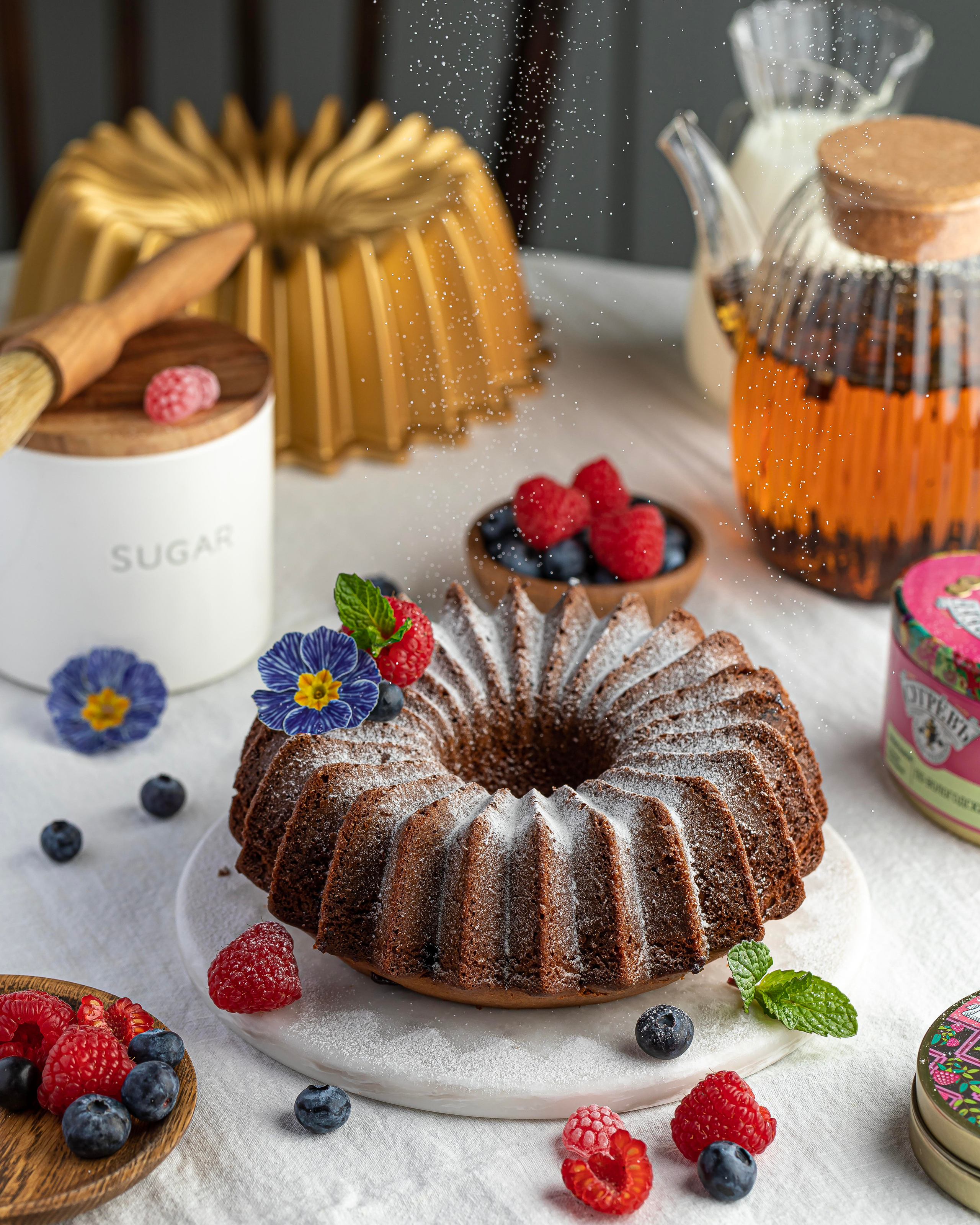 Разработка рецептур для бизнеса и производителей продуктов питания. Фигурная форма для выпечки в композиции с посудой и чаем. Светлый фон, текстиль, лен.