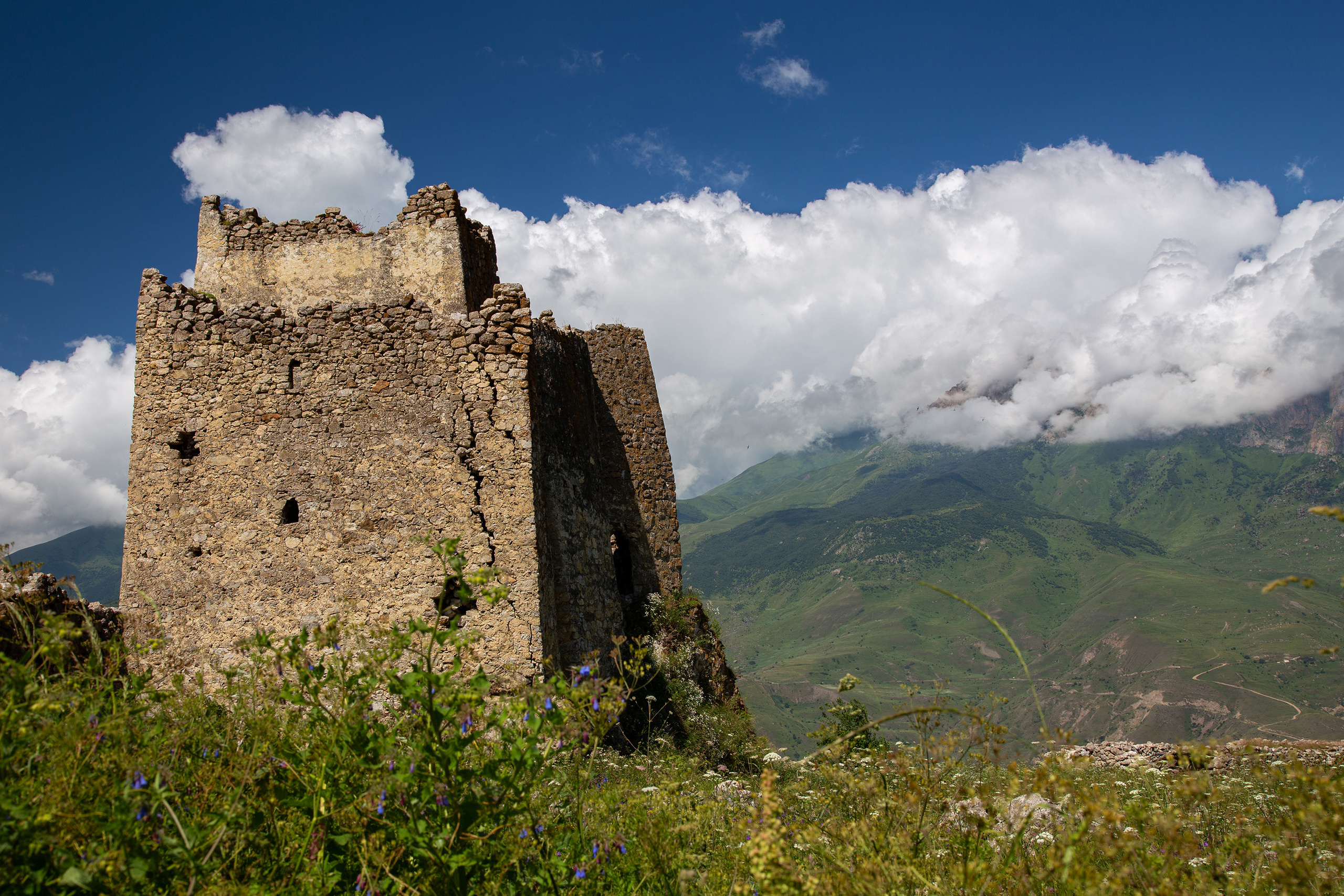 Родовая башня Цаллаевых или Фатцаевых Фрегат в Ханазе на фоне облаков. Дигорское ущелье, Осетия